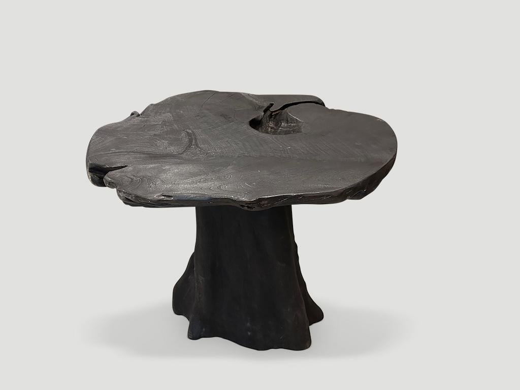 Sculptural reclaimed teak wood side table or pedestal. The top is an impressive thick single slab. Charred, sanded and sealed revealing the beautiful wood grain. Both sculptural and usable. 

The Triple Burnt Collection represents a unique line of