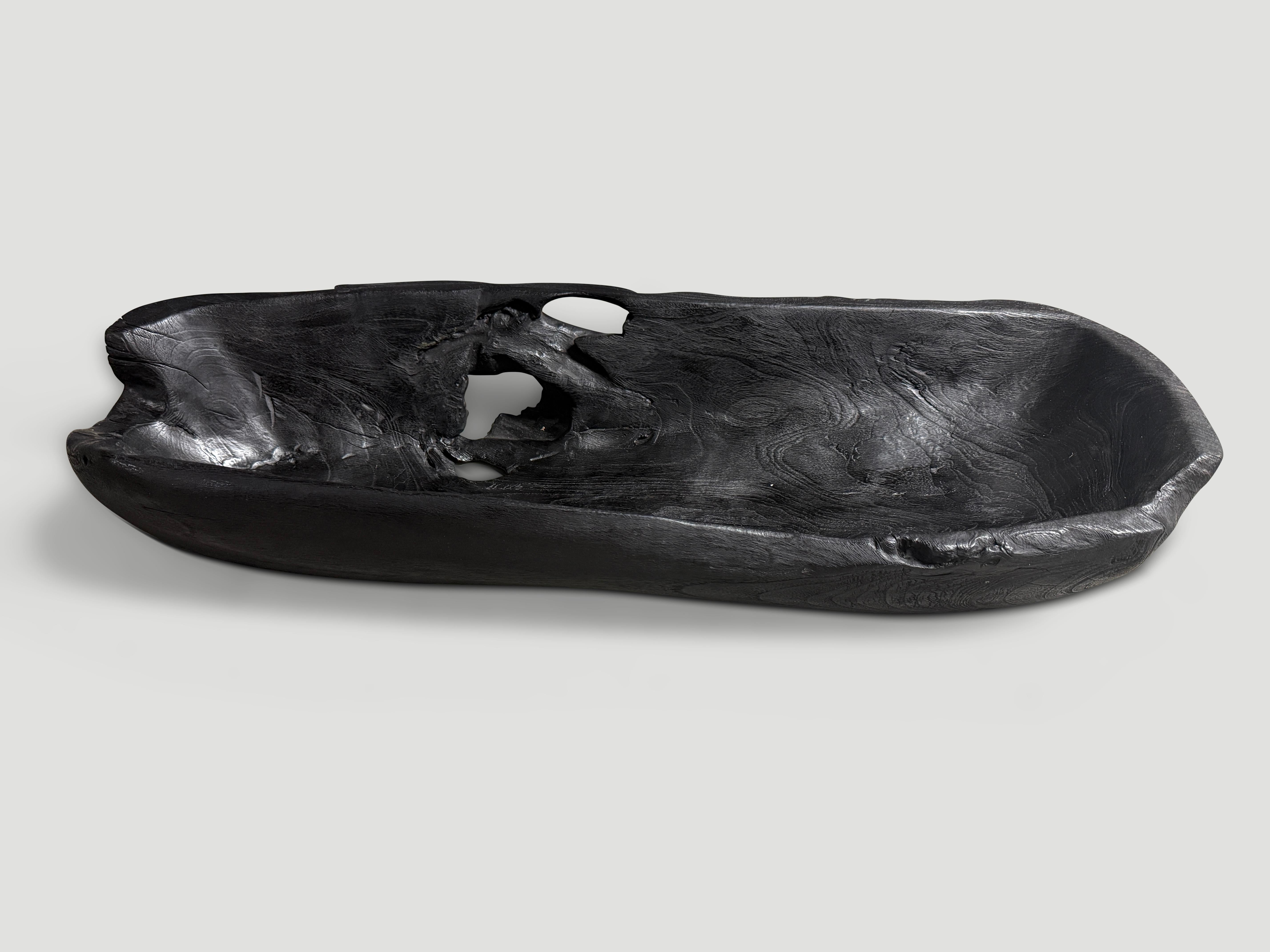 Impressive long charred vessel hand carved from a single piece of reclaimed teak wood. Both usable and sculptural. Charred sanded and sealed revealing the beautiful wood grain. It’s all in the details. We have a collection. All one of a kind. The
