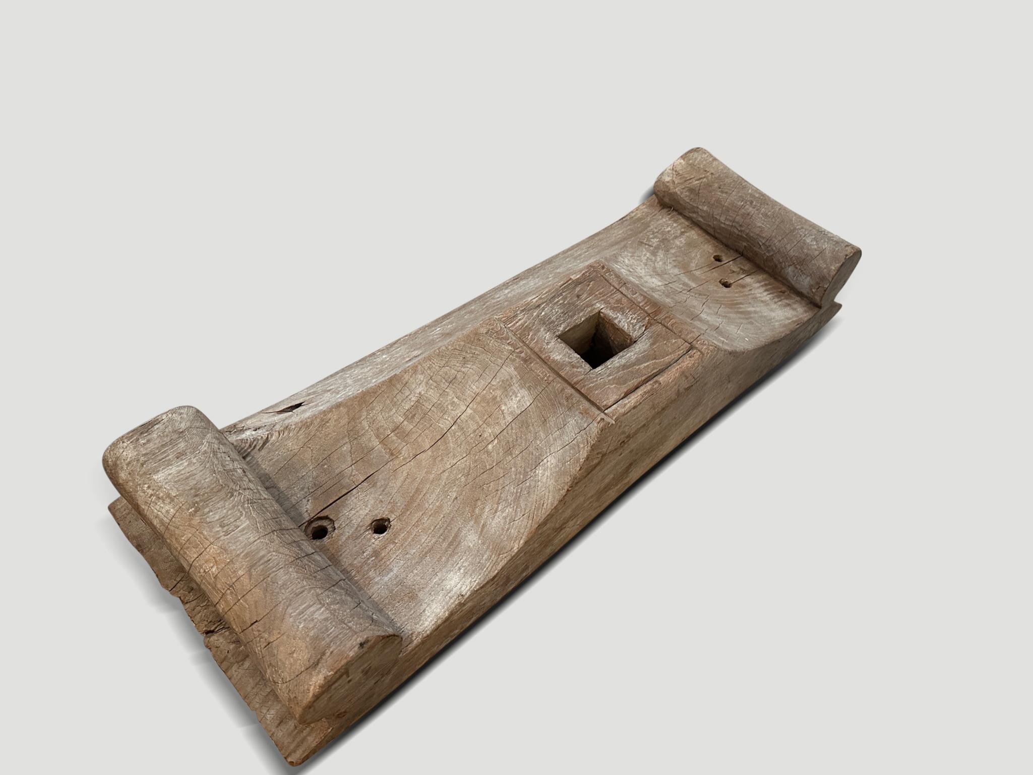 Beautiful architectural base with hand carved scrolls on each end. Originally used as a base for an interior column, hence the hole in the center. Three sides are bevelled and one side flat, so this could also be hung and used as a shelf, as shown