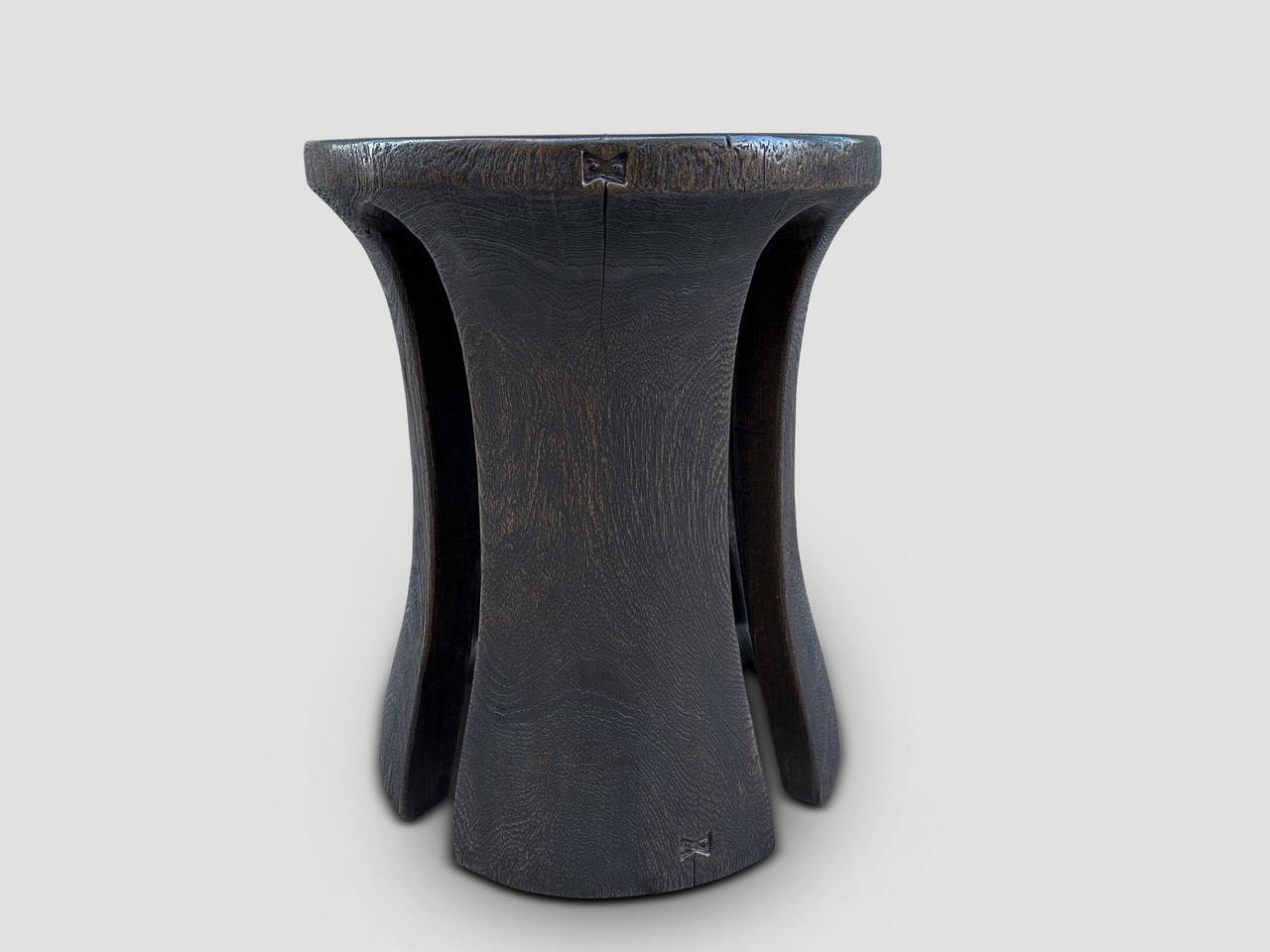A century old teak wood mortar originally used to grind rice, is repurposed into this minimalist side table or stool. We first turned it upside down and smoothed out the entire piece and then made sleek cut outs and added recessed butterflies inlaid