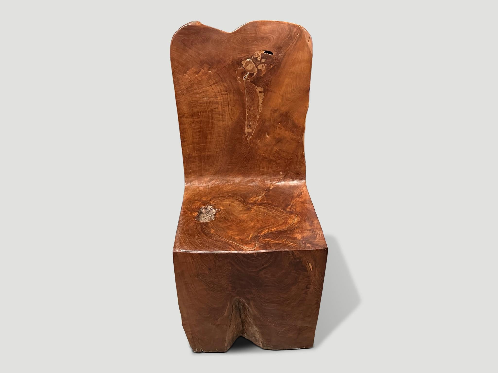 Beautiful aged teak wood hand carved chair. A single block of wood has been hand carved into this solid teak sculptural chair whilst respecting the natural organic wood. We have a set of four. The price and images reflect the one shown. Full
