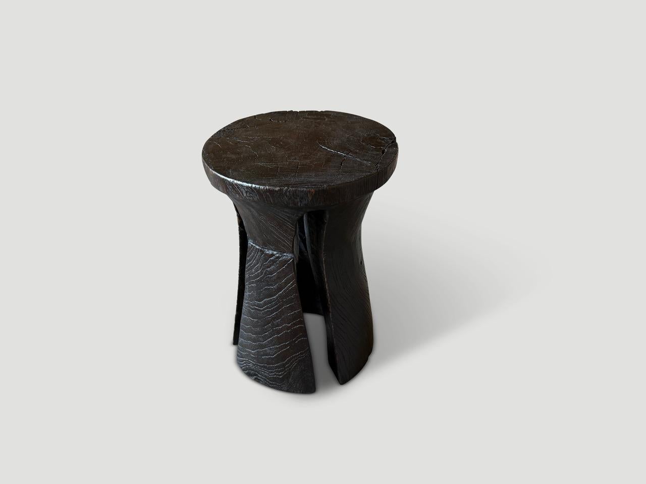 A century old teak wood mortar originally used to grind rice, is repurposed into this minimalist tall side table, stool or pedestal. We first turned it upside down and smoothed out the entire piece and made sleek cut outs into the sides. Finished