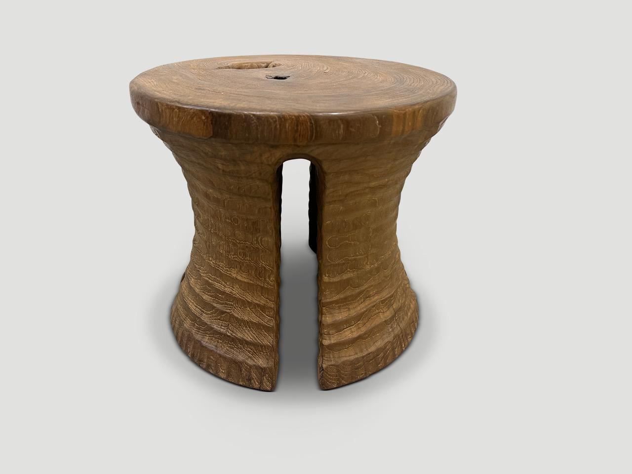 A century old teak wood mortar originally used to grind rice, is repurposed into this minimalist side table or stool. Part of the Mid Century Couture Collection, featuring our unique minimalist carving. We first turned this ancient piece upside down