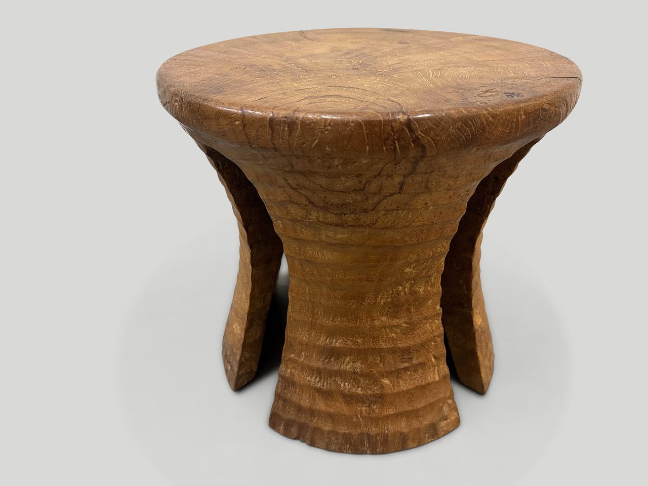 A century old teak wood mortar originally used to grind rice, is repurposed into this minimalist side table or stool. Part of the Mid Century Couture Collection, featuring our unique minimalist carving. We first turned this ancient piece upside down