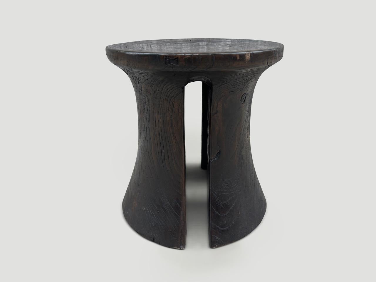 A century old teak wood mortar originally used to grind rice, is repurposed into this minimalist side table or stool. We first turned it upside down and smoothed out the entire piece then added sleek cut outs on the sides with small butterfly inlays