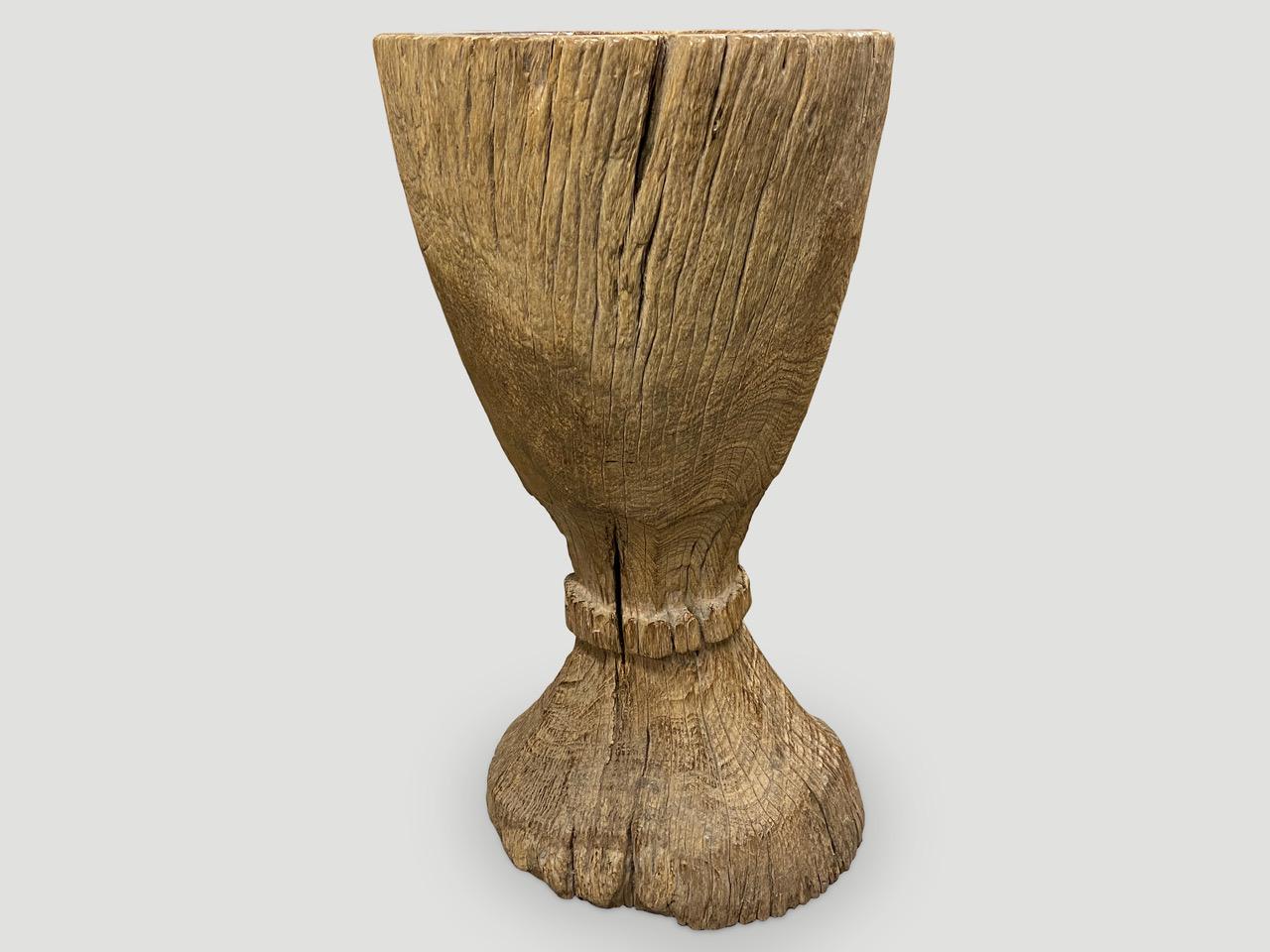 Antique rice pounder hand carved from a single teak root. Beautiful as a sculpture, holding towels or great as a champagne holder for parties. Also as a table base with a glass top.

This rice pounder was sourced in the spirit of Wabi-Sabi, a