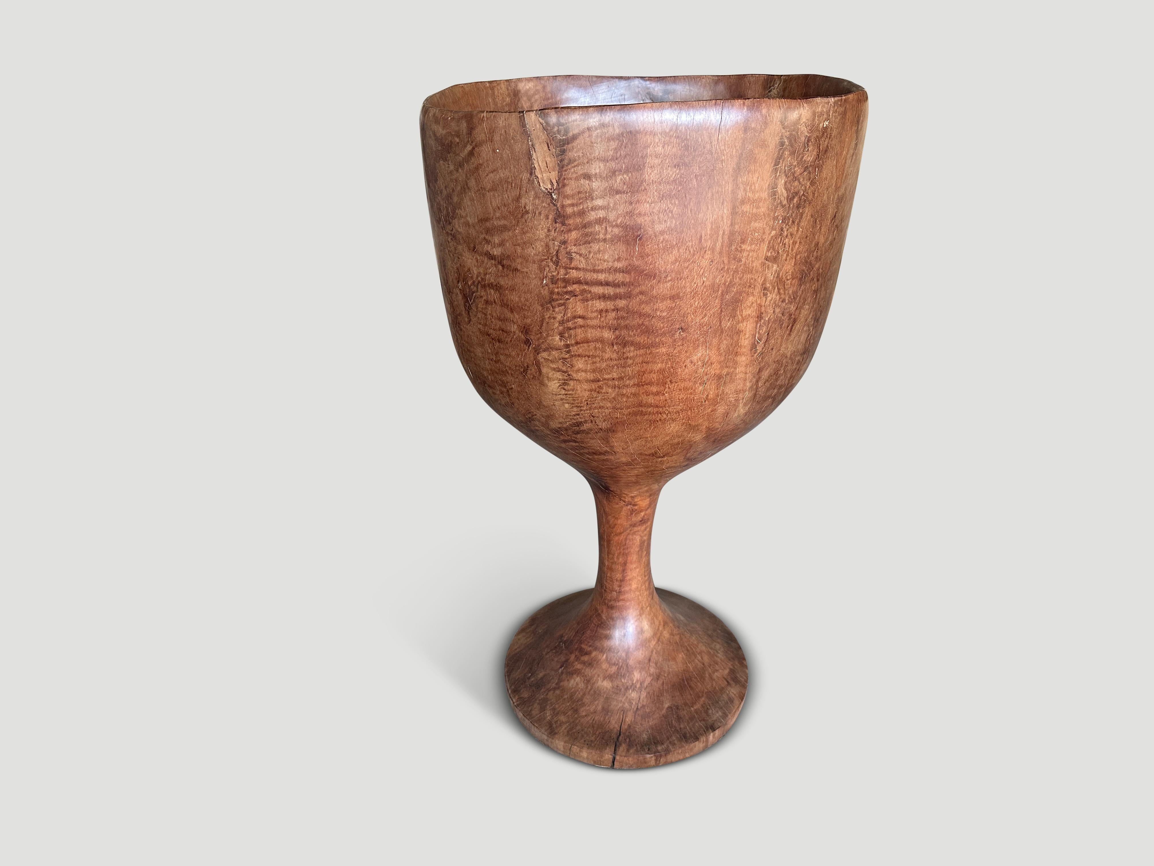 Sculptural vessel hand carved from a single reclaimed block of lychee wood. Great as an art object, holding towels by a pool perhaps or as a planter. Both usable and sculptural. Finished with a natural oil revealing the beautiful wood grain. Full