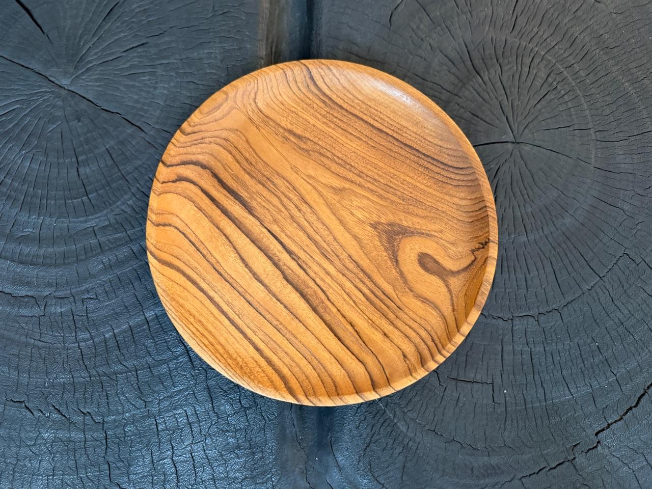 Satz von fünf minimalistischen Tellern mit niedrigem Profil. Es gibt so viele Verwendungsmöglichkeiten für diese einfachen, aber einzigartigen Accessoires. Mit einem natürlichen Öl behandelt, das die schöne Holzmaserung zum Vorschein bringt.