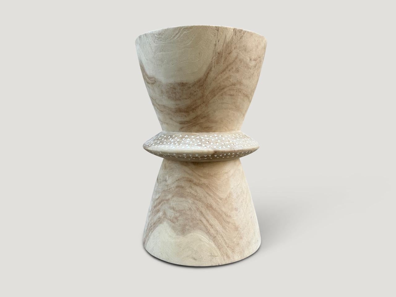 Beautiful hand carved teak wood side table with added shell inlay to the center section. First bleached and finished with a light white wash revealing the unique contrasting wood grain. It’s all in the details. Custom stains available. Please