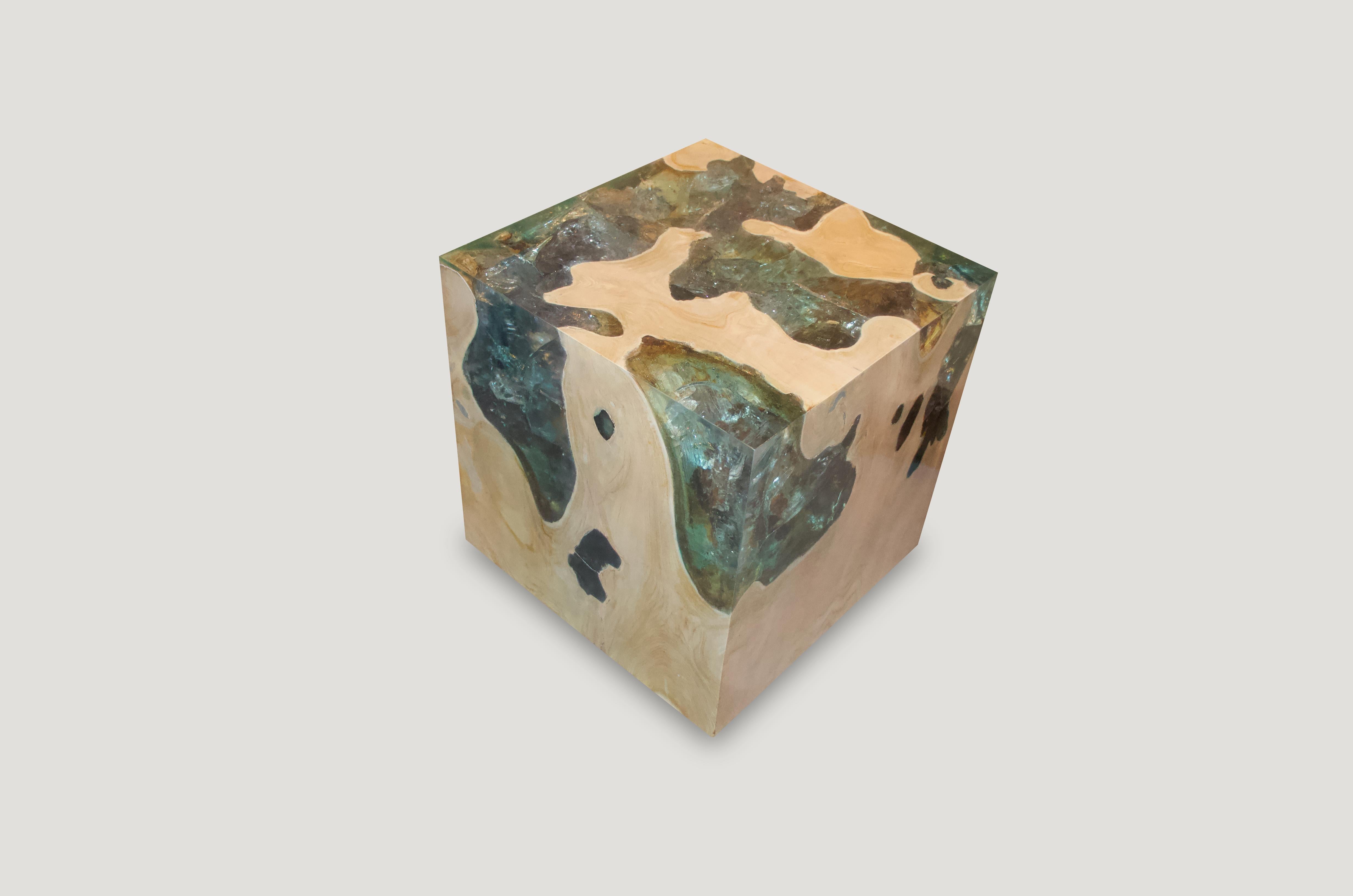 The St. Barts side table is a unique variation of the teak and cracked resin cube. Ice blue or aqua resin is first cracked and added into the natural grooves of the bleached teak wood, sanded and finished with a high polish. Handmade from reclaimed
