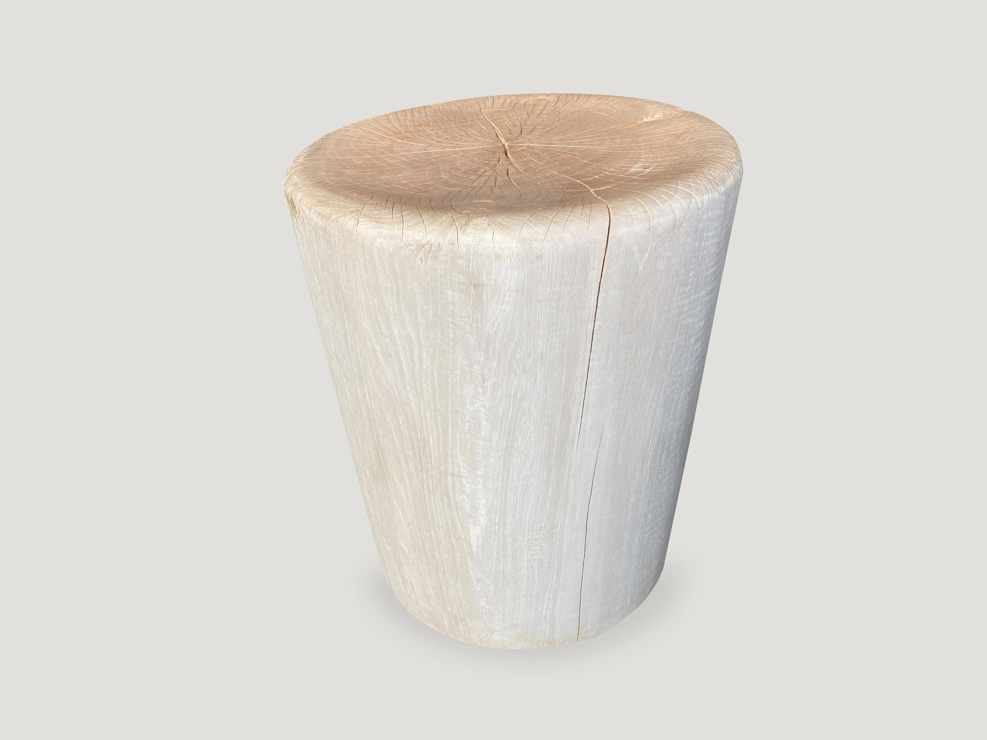 Reclaimed teak wood side table or stool. Hand carved with soft rounded sides, into a drum shape whilst respecting the natural organic wood. Bleached to a bone finish. There is a slight graduation from the bottom to the top. Also available