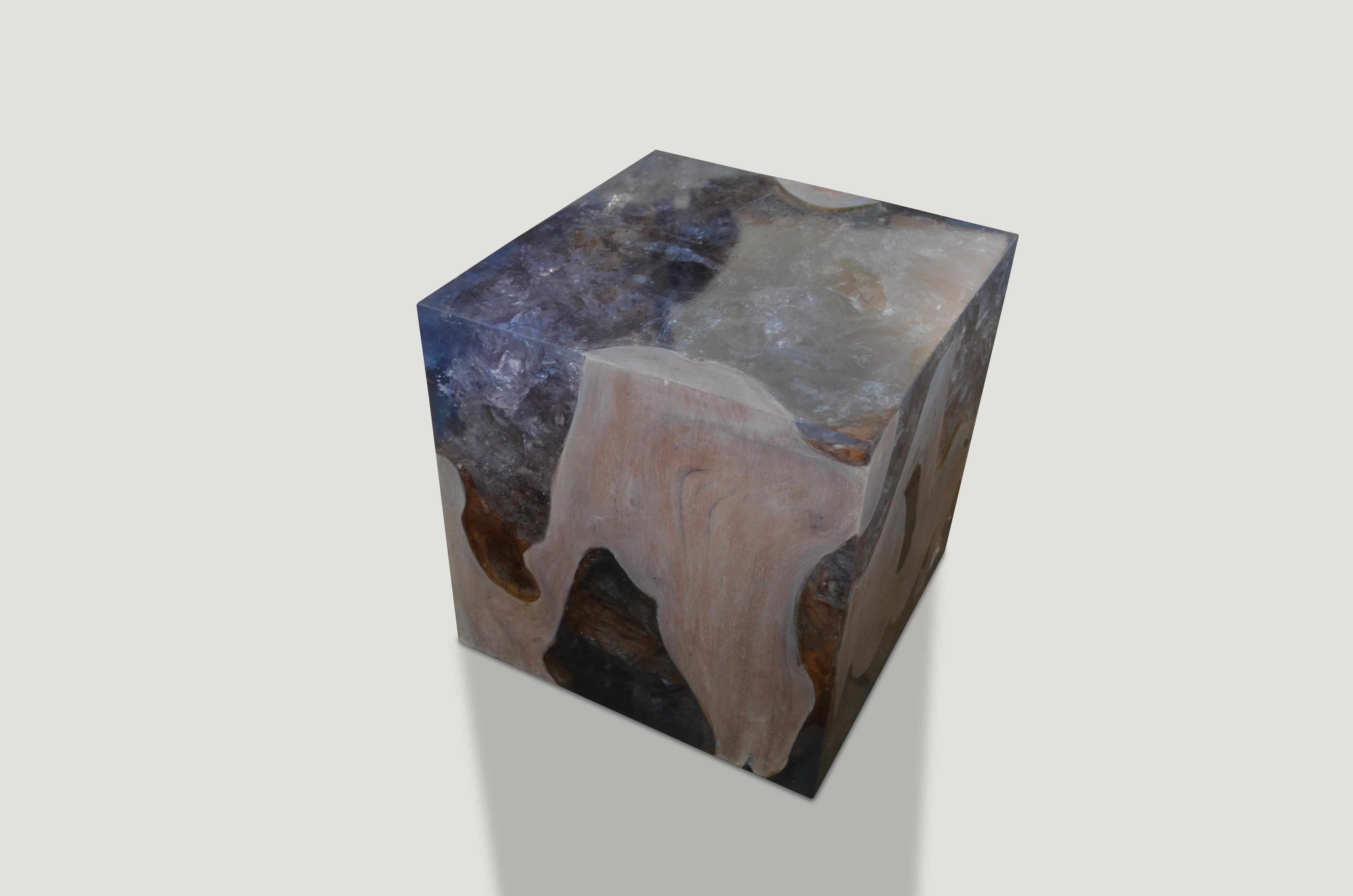 The St. Barts side table is a unique variation of the teak and cracked resin cube. Ice blue or aqua resin is first cracked and added into the natural grooves of the bleached teak wood, sanded and finished with a high polish. Hand made from reclaimed