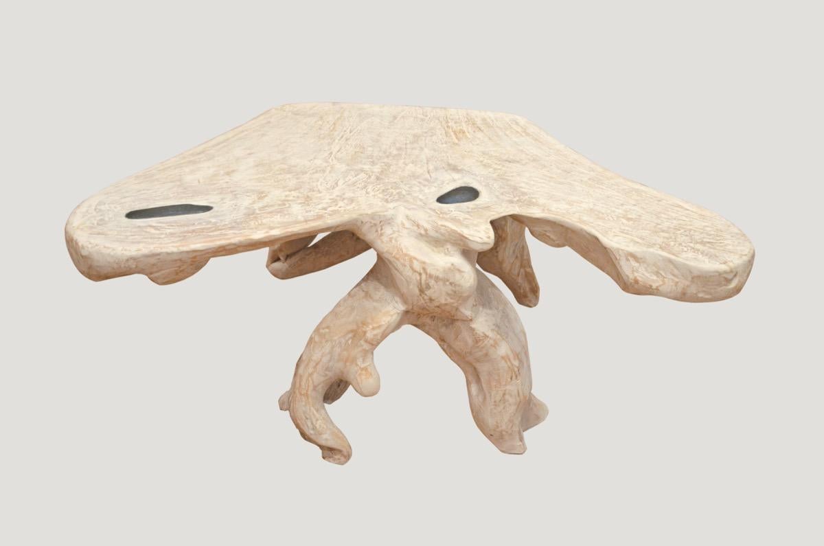 Organic teak wood coffee table with a white wash finish and added blue resin. Carved from a single reclaimed teak wood root.

The St. Barts Collection features an exciting new line of organic white wash and natural weathered teak furniture. The