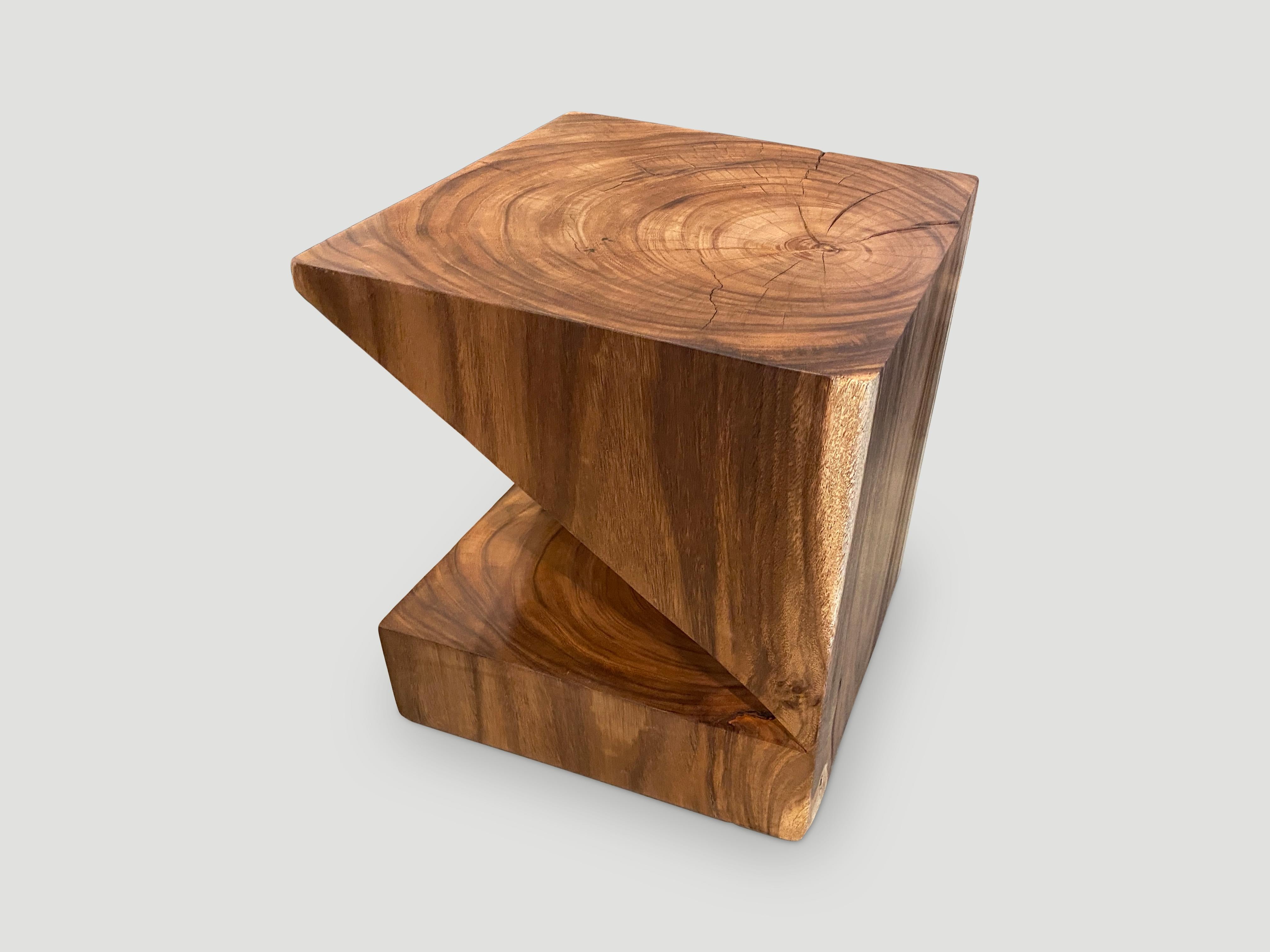 Solid reclaimed suar wood side table with a natural oil finish revealing the beautiful wood grain. Inspired by the art of paper folding which is often associated with Japanese culture. Shown in natural and also available charred. Pair available. The
