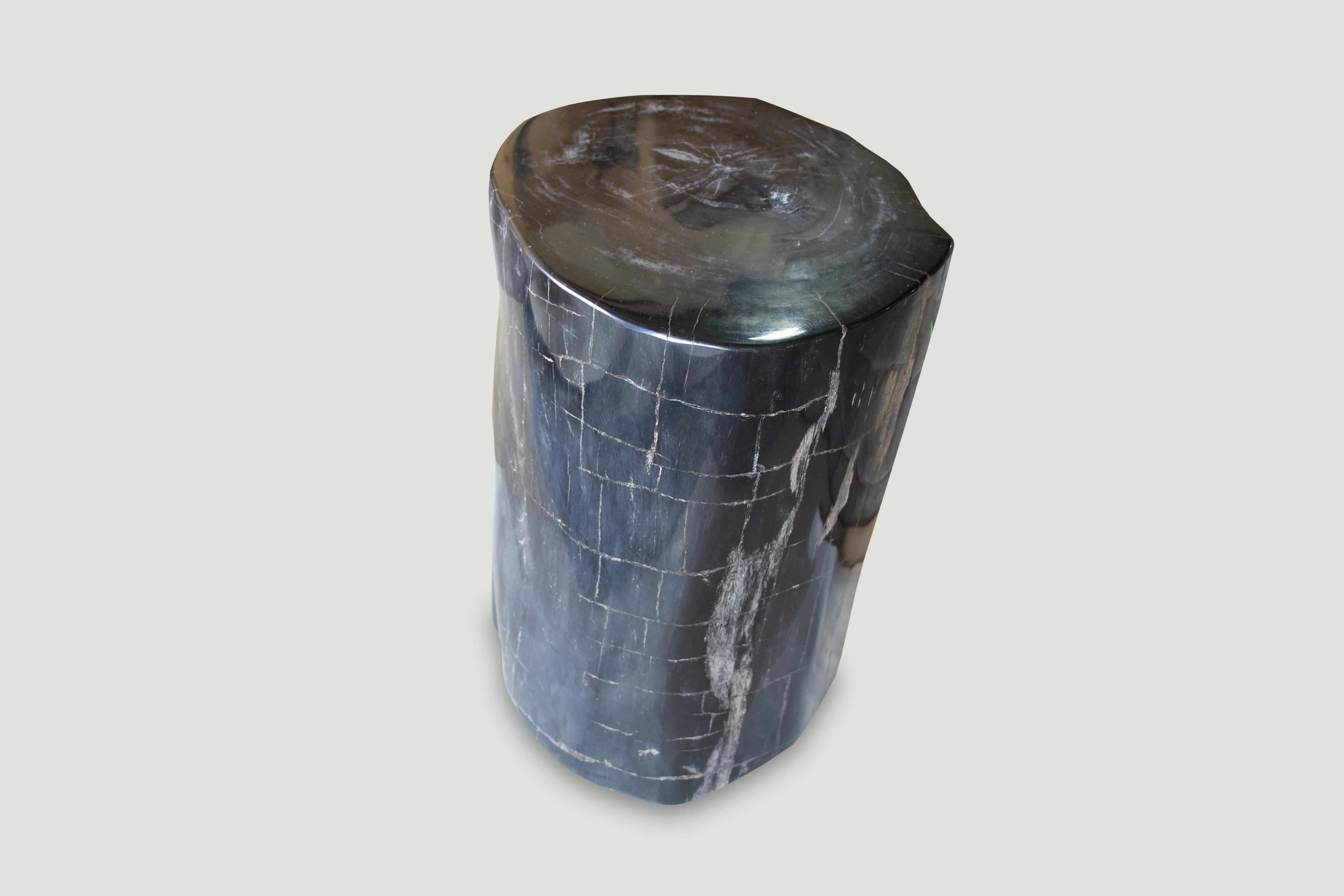 Super smooth black with natural occurring checkered grey pattern on this high quality petrified wood side table.

As with a diamond, we polish the highest quality fossilized petrified wood, using our latest ground breaking technology, to reveal