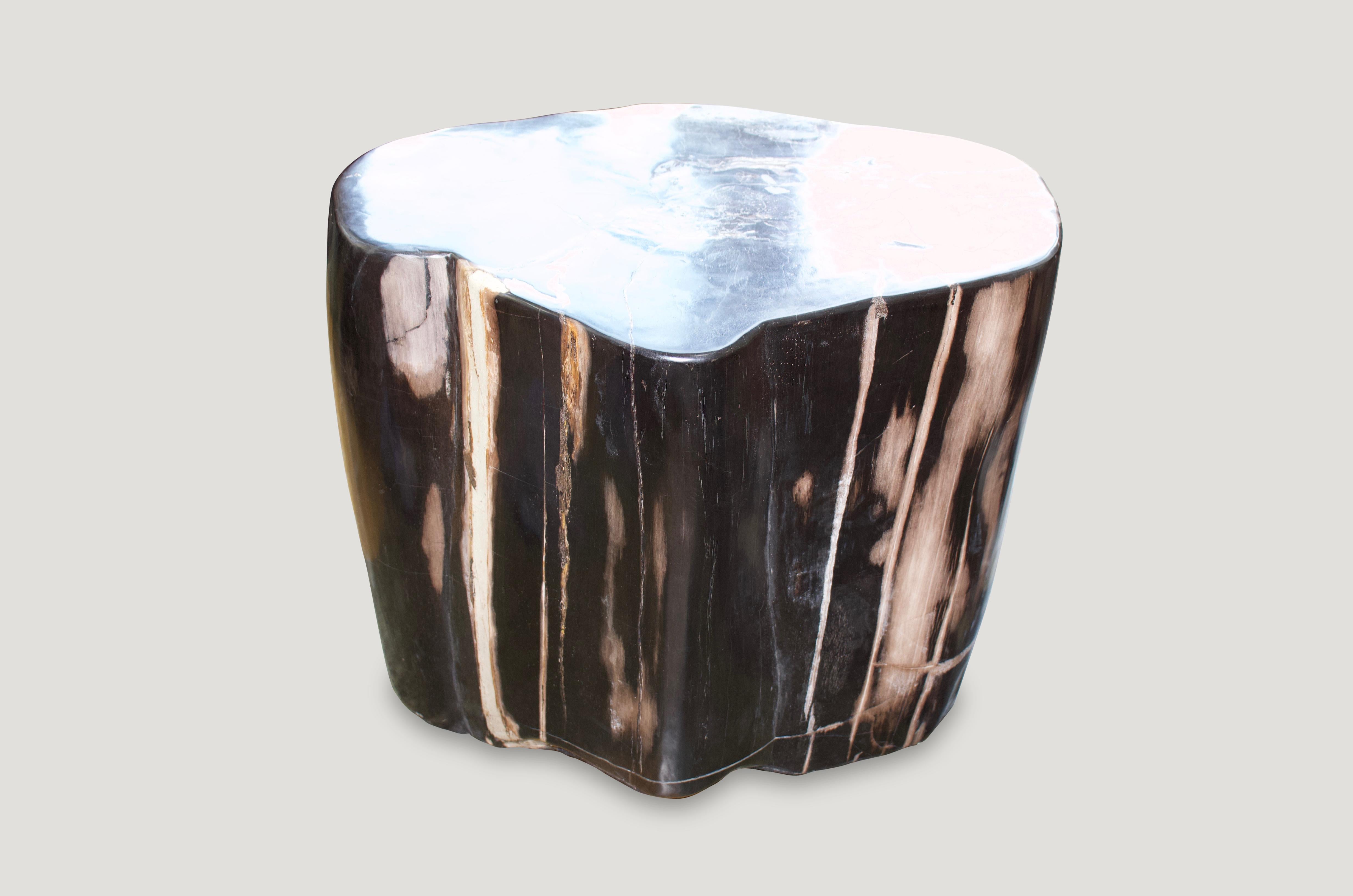Fabulous color tones on this super smooth petrified wood side table. We have a pair available, cut from the same petrified log. The price reflects one.

We source the highest quality petrified wood available. Over 40 million years old. Each piece