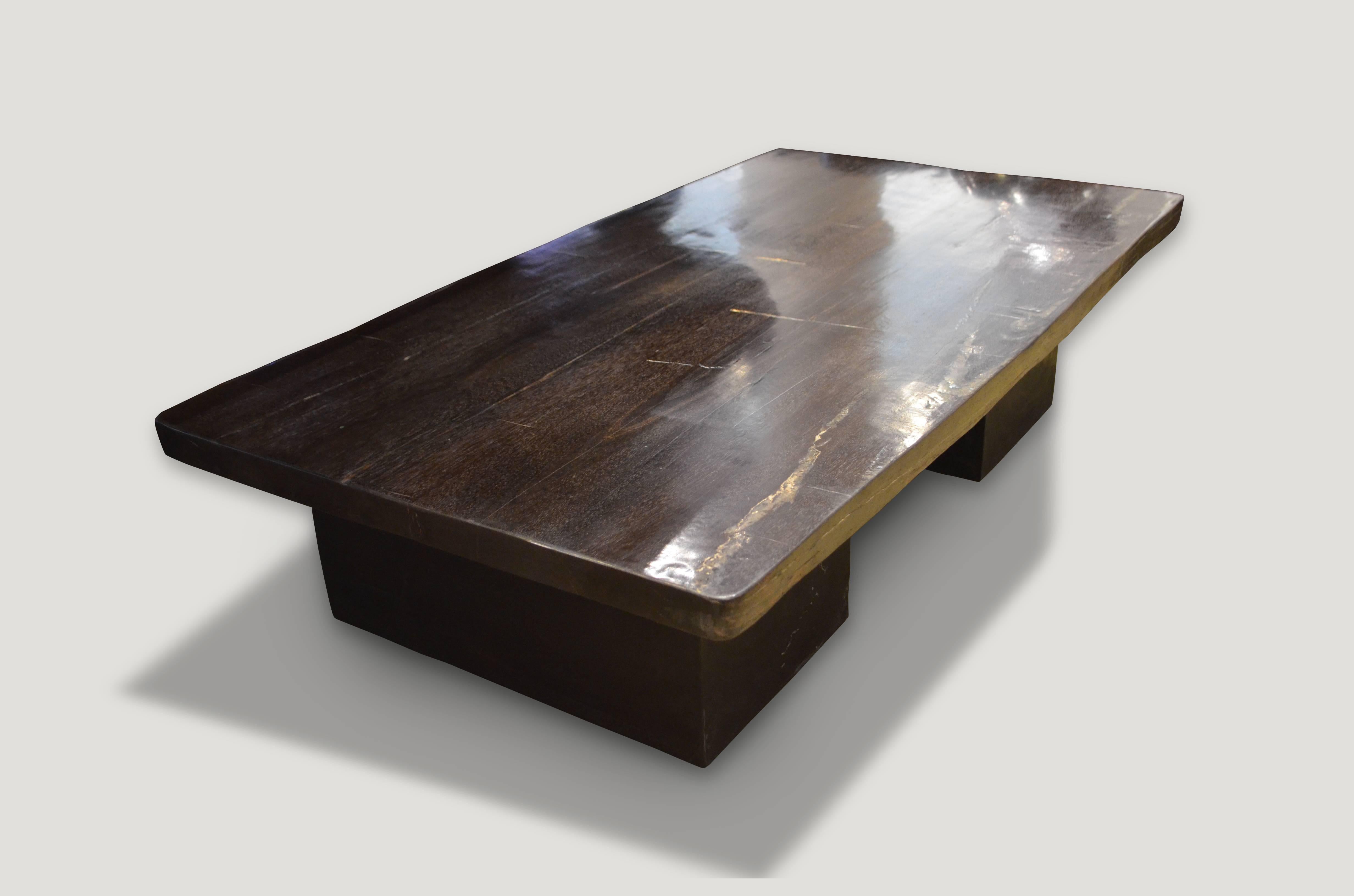 High quality super smooth petrified wood coffee table, dining table or counter top. Stunning charcoal grey, black and contrasting beige and white natural tones make this an impressive piece for any space. This two inch thick slab is shown floating