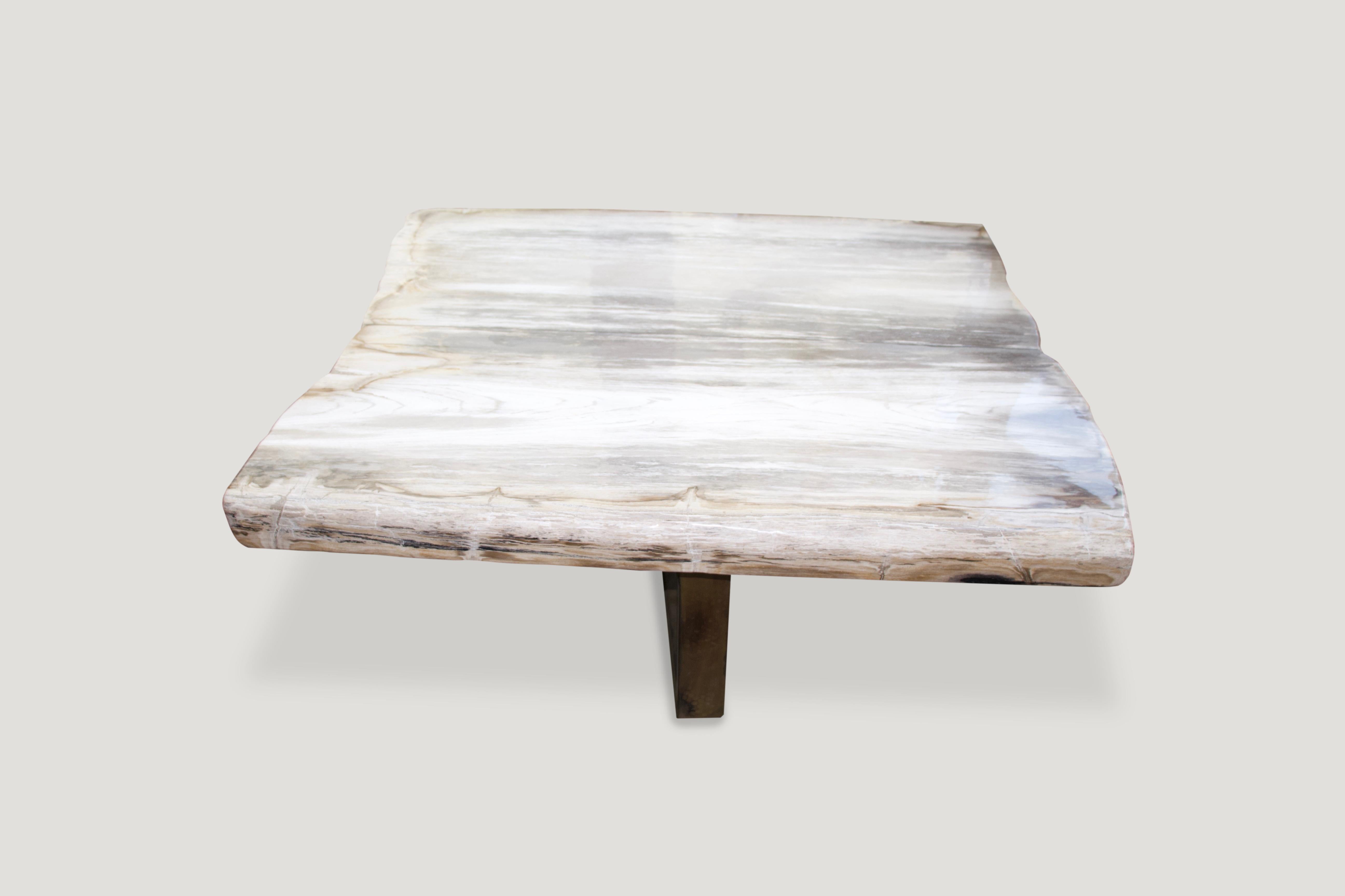 High quality super smooth petrified wood coffee table or counter top. Stunning grey and beige tones on this impressive three inch slab. The height can be modified depending on the base. Currently shown on a wooden base as well as a bronze