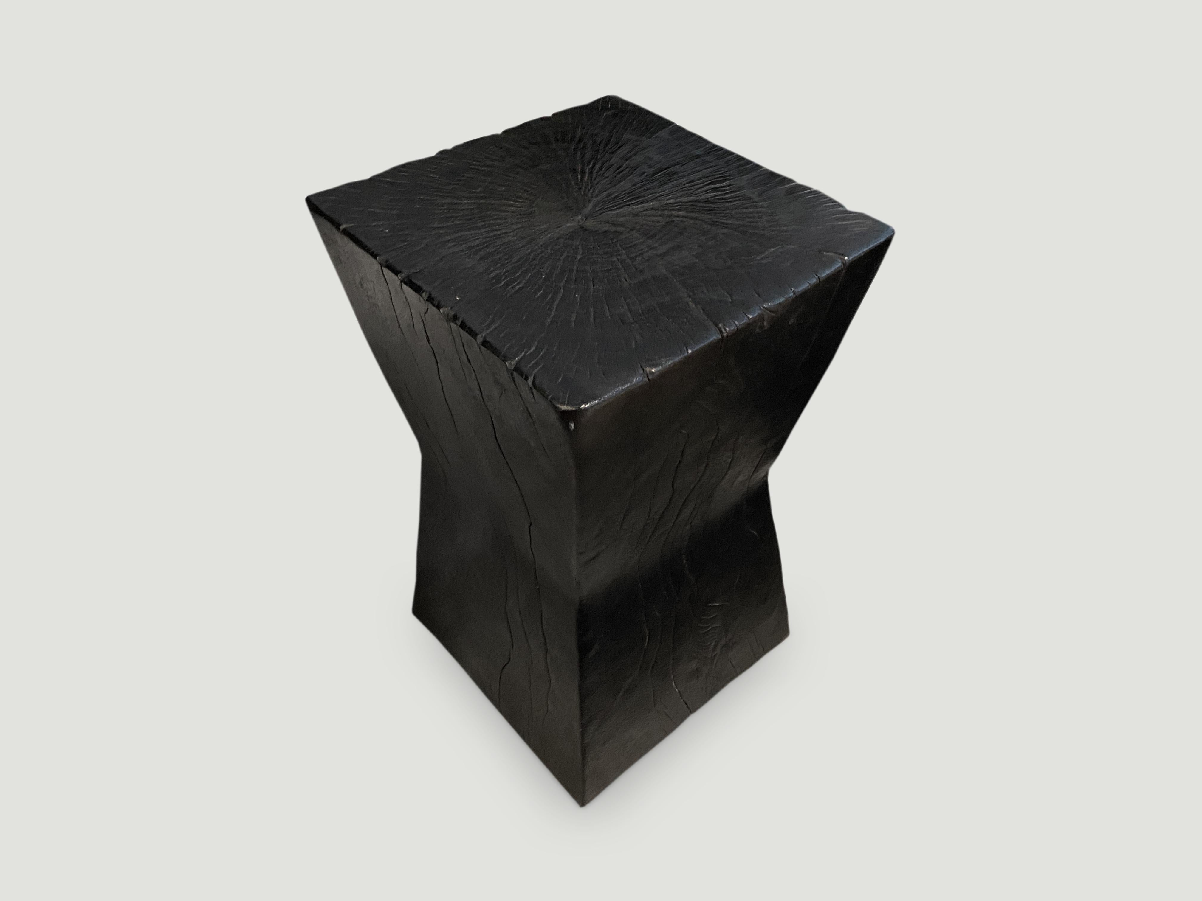 Reclaimed hourglass shaped tamarind wood side table. Hand carved whilst respecting the natural organic wood. Burnt, sanded and sealed. We have a collection. The price and size reflect the one shown. 

The Triple Burnt collection represents a