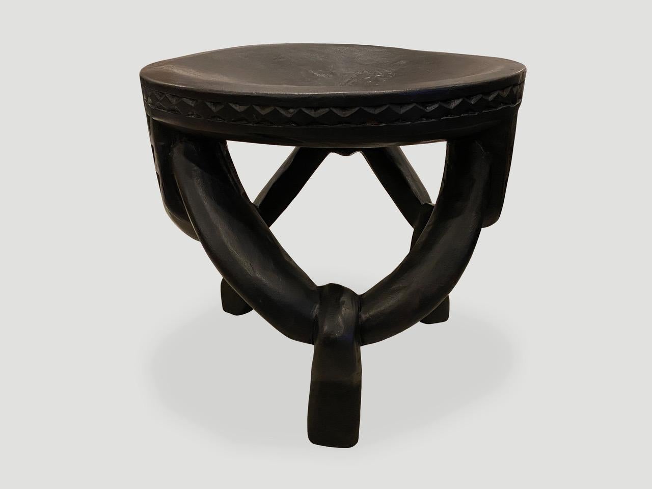 Impressive antique African mahogany side table or stool, hand carved from a single block of mahogany wood. Great for placing a book or perhaps towels in a bathroom, magazines etc. A beautiful, versatile item that is both sculptural and usable. This