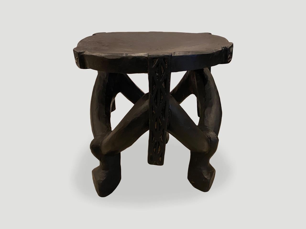 Impressive antique African mahogany side table or stool, hand carved from a single block of mahogany wood. Great for placing a book or perhaps towels in a bathroom, magazines etc. A beautiful, versatile item that is both sculptural and usable. We