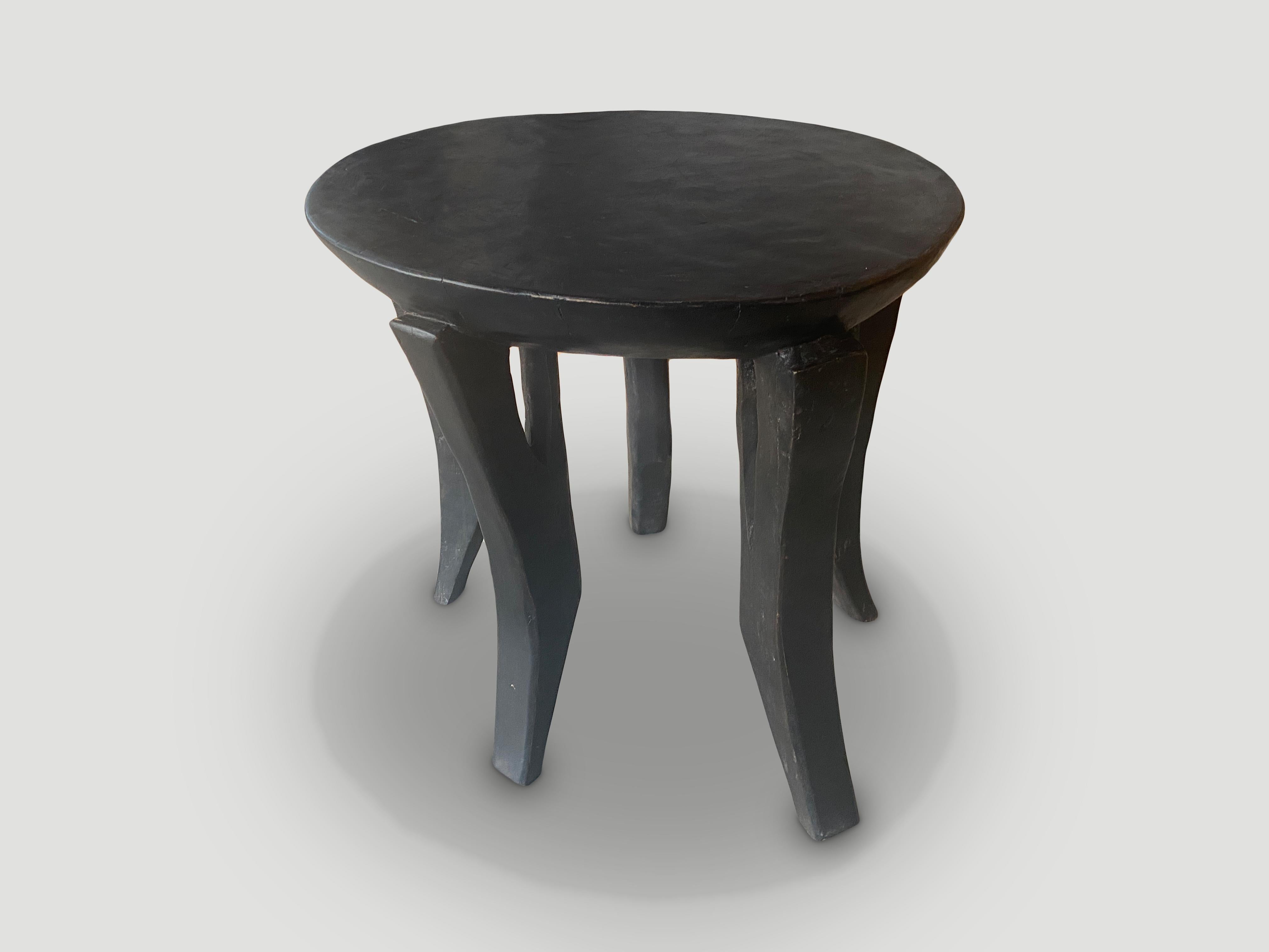 Impressive antique African mahogany side table hand carved from a single piece of mahogany wood with a four inch bevelled top. A beautiful versatile item that is both sculptural and usable. We only source the best. 

This side table was sourced in