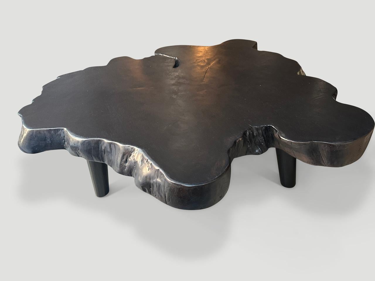 Impressive 3.5” thick teak coffee table floating on mid century style legs. A blend of organic and mid century.

The Triple Burnt Collection represents a unique line of modern furniture and art objects hand made from solid organic wood. Burnt three