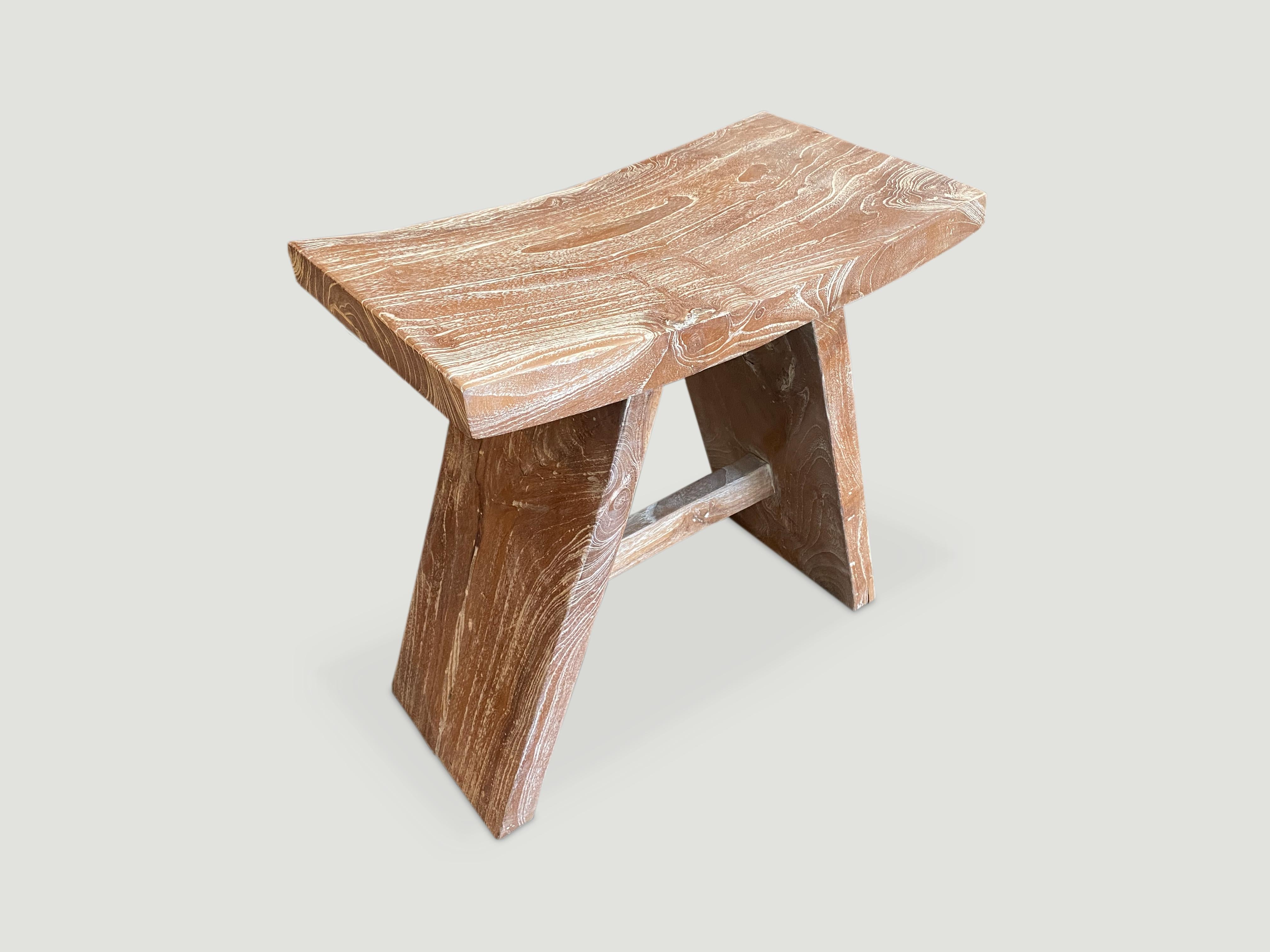 Teak ‘A’ Bench as seen in Architectural Digest. This reclaimed teak wood bench represents a modern, Minimalist aesthetic Perfect anywhere from a bathroom, kitchen or bedroom with the top section made from a single teak slab. We added a light cerused