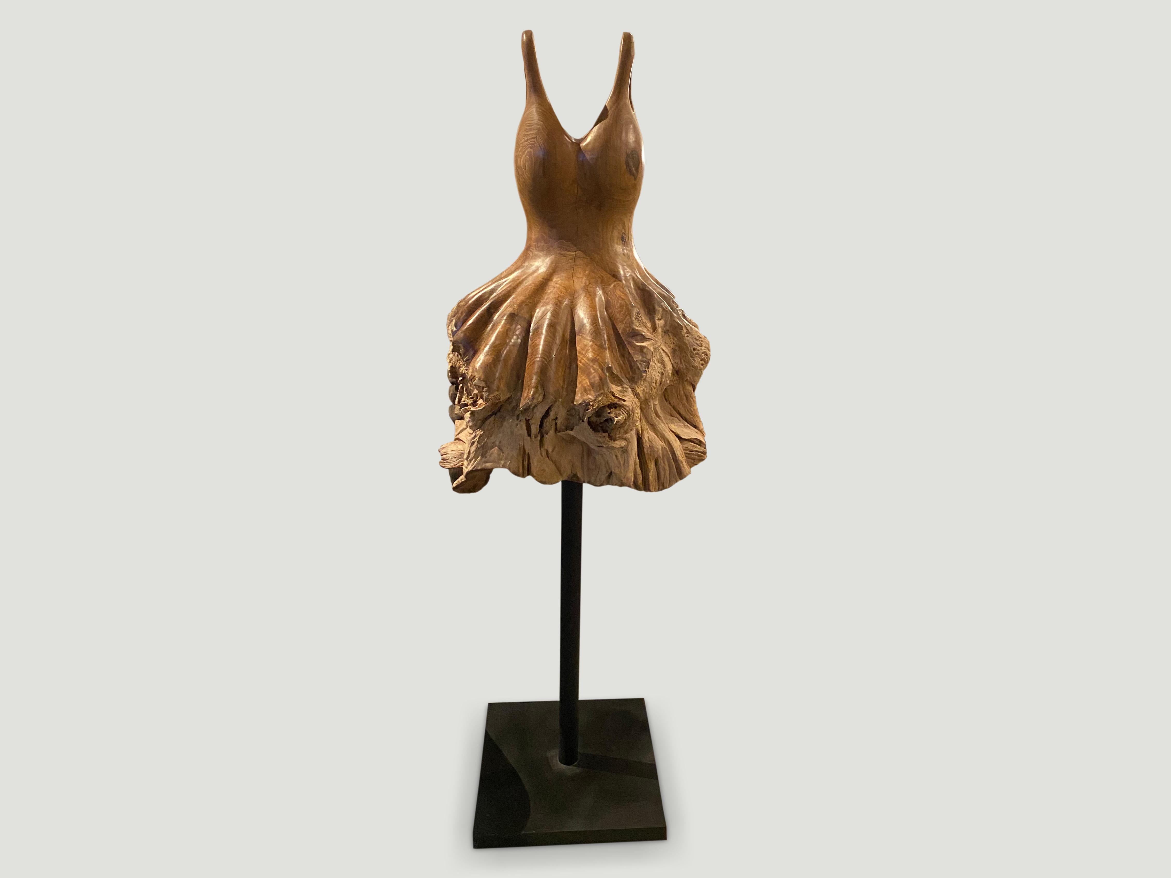 Hand carved from a single teak root, a beautiful ballerina dress. We left the bottom section raw in contrast with the top section which has been sanded and polished with a natural oil finish revealing the natural beauty of the wood. Set on a modern