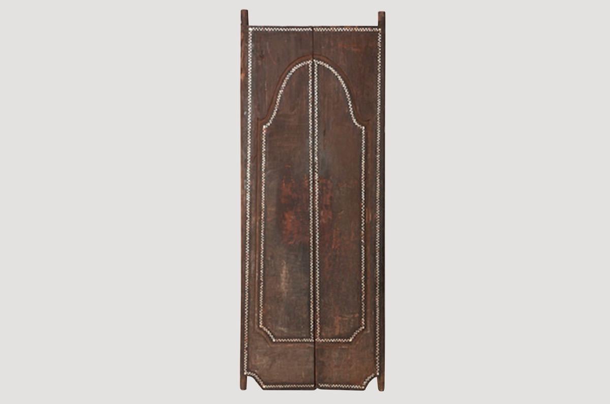 Andrianna Shamaris temple doors in teak wood. We added the shell inlay by hand for that special finish. Great as a headboard or accent piece. Can also be used as a tabletop. We currently have a large collection of temple doors available in many