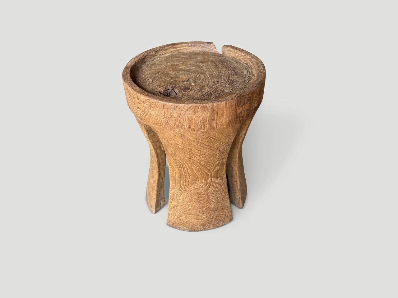 A century old teak wood mortar originally used to grind rice, is repurposed into this minimalist side table with a tray style top. We turned it upside down and added sleek cut outs to the sides and butterflies inlaid into the wood. Finished with a