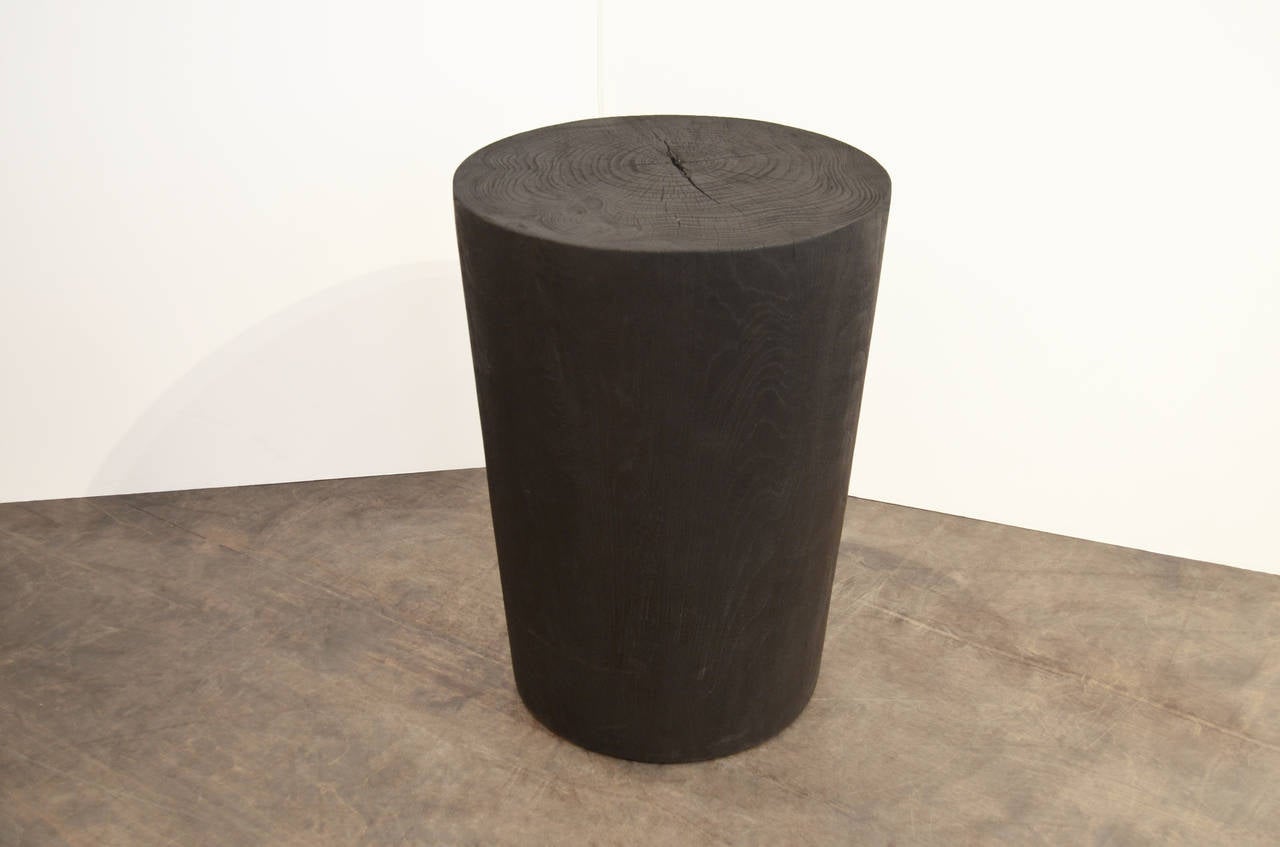 Solid cylinder reclaimed teak side table or pedestal. Charred, sanded and sealed revealing the beautiful wood grain. Custom stains and finishes available. Please inquire.

The Triple Burnt Collection represents a unique line of modern furniture made