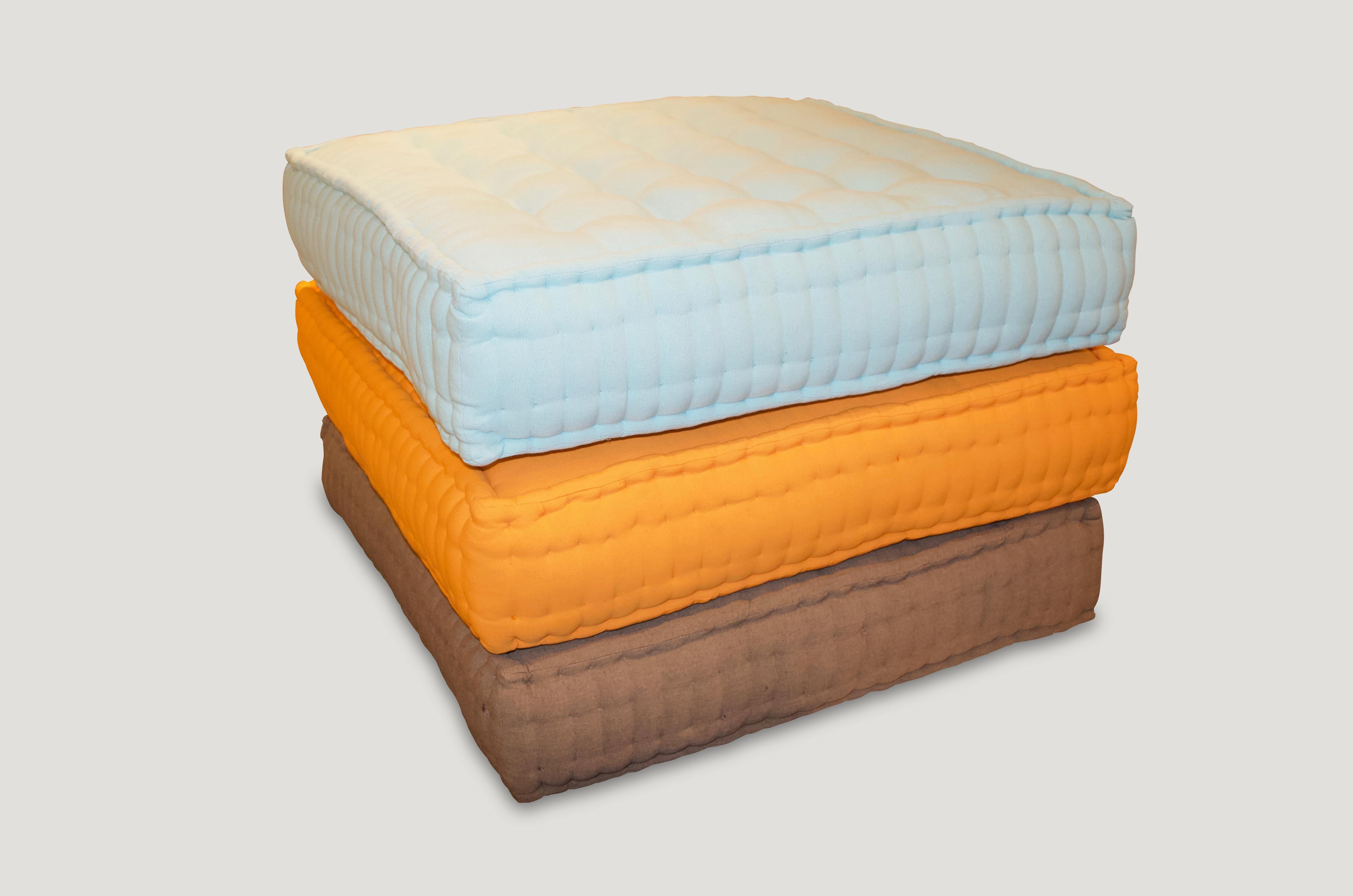 Cotton floor pillows. Available in Khaki, Tangerine and Turquoise. The price reflects one.

 