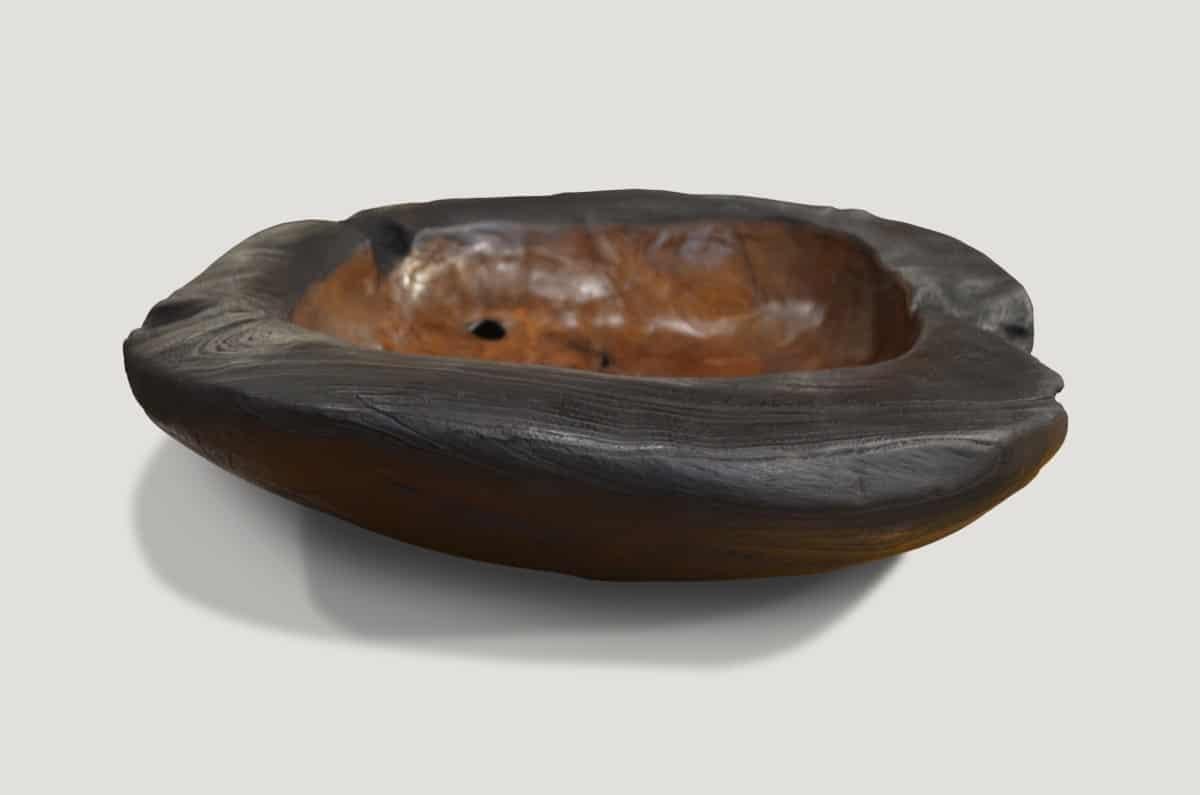 The organic teak wood vessel serves as a stunning sculptural piece and a practical addition to hold fruit, magazines, towels, etc. Carved from a single piece of reclaimed teak wood.

Own an Andrianna Shamaris original.

Andrianna Shamaris. The