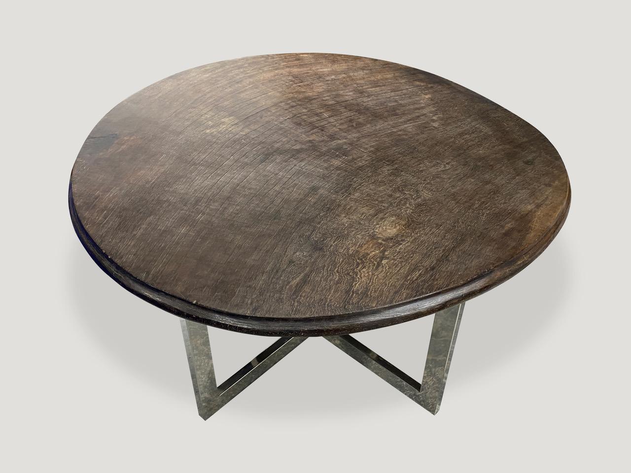 Impressive single slab top ulin wood coffee table from Kalimantan. Stunning patina and hand carved beveled edge on this antique top. We added a contrasting modern steel base. 1