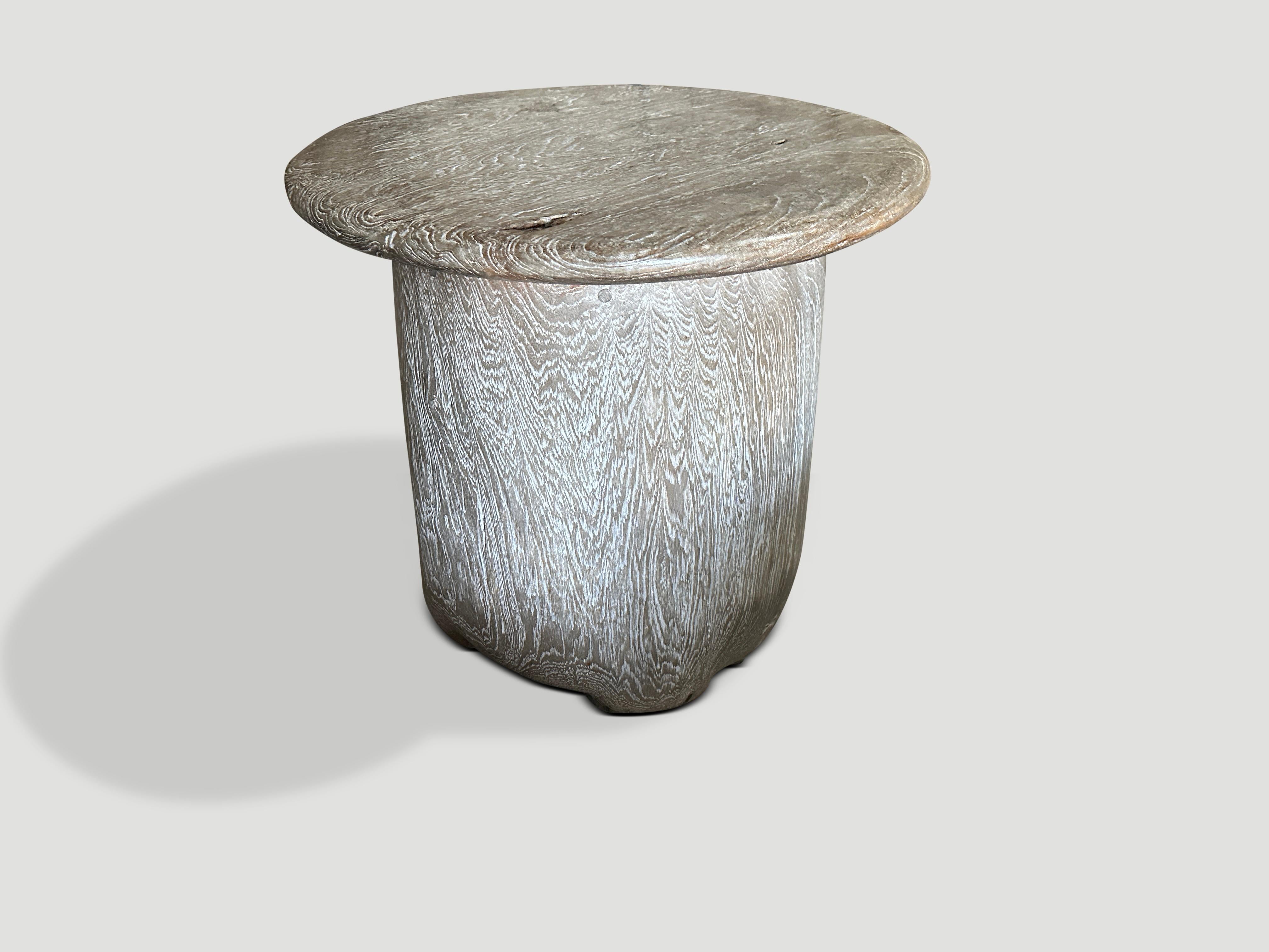 A beautiful antique drum style base with a three inch thick exquisite bevelled round top. Perfect as a side table or entry table. We added a translucent grey stain and a ceruse finish revealing the impressive wood grain. It’s all in the details.