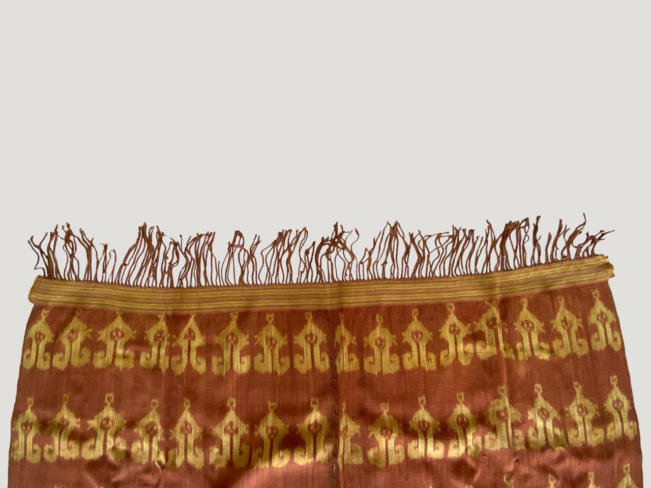 Classic ikat from the island of Sumba with golden and burnt orange tones. Fabulous on a sofa, bed or a wall hanging. Ikat is an ancient technique which is used to add patterns to textiles. The designs are created in the yarns rather than on the