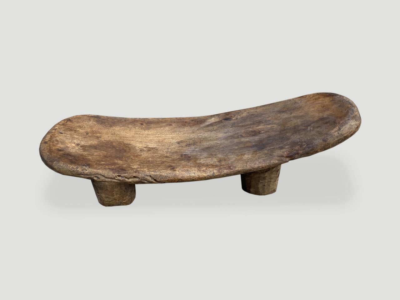Beautiful antique African bench or chaise with lovely patina. Hand carved from a single block of wood, native to the west coast of Africa. Great to sit on or in a bathroom perhaps for towels. We only source the best. 

This bench or chaise was