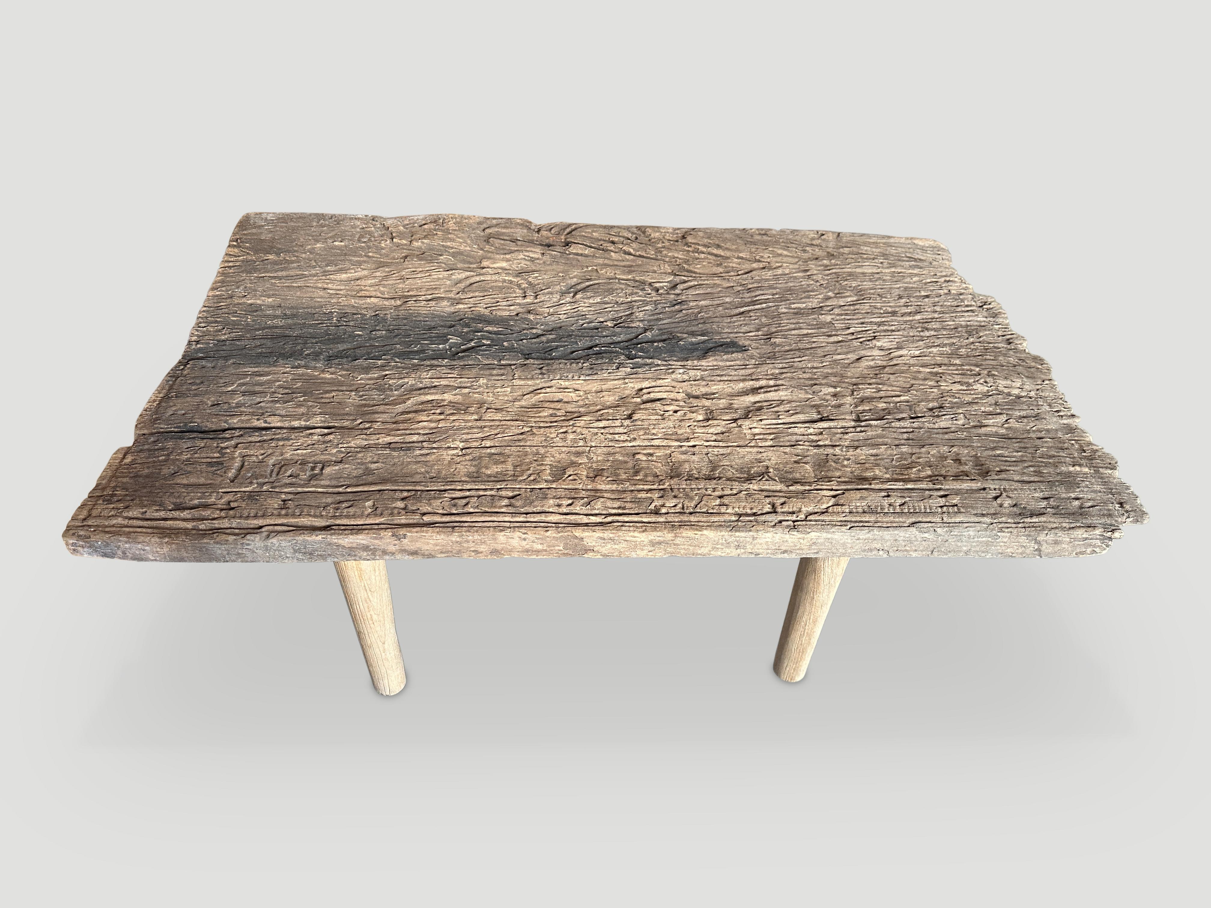 Beautiful Wabi Sabi hand carved coffee table. We added minimalist legs to this single wood piece originally used as an architectural panel. 

This coffee table was hand made in the spirit of Wabi Sabi, a Japanese philosophy that beauty can be found