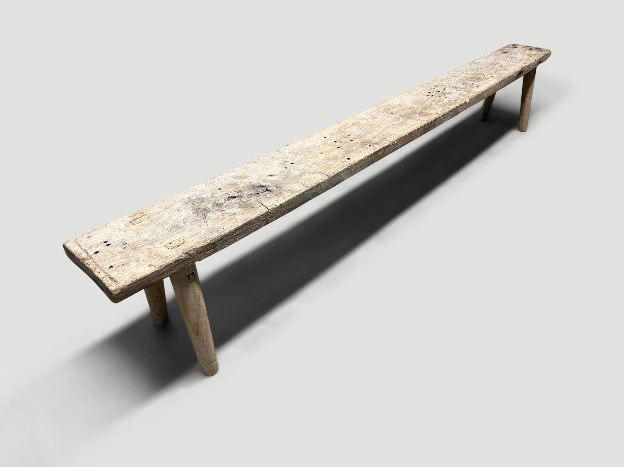 Antique Wabi Sabi teak bench celebrating the cracks and crevices and all the other marks that time and loving use have left behind. We added smooth teak minimalist legs to this antique thick slab. It’s all in the details.

This bench was handmade in