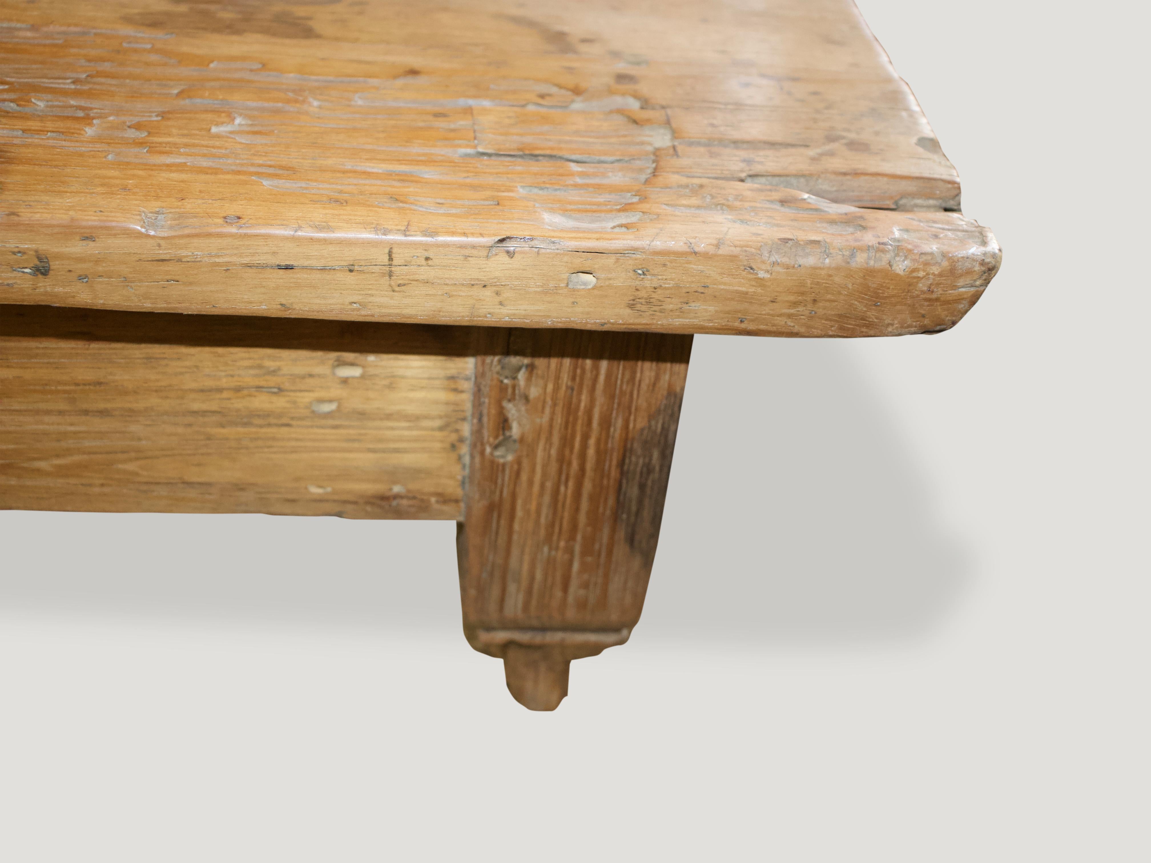 Antique coffee table with a single drawer and the top made from a single slab of natural aged teak. This low profile coffee table celebrates cracks and crevices and all the other marks that time and loving use have left behind.

This table was