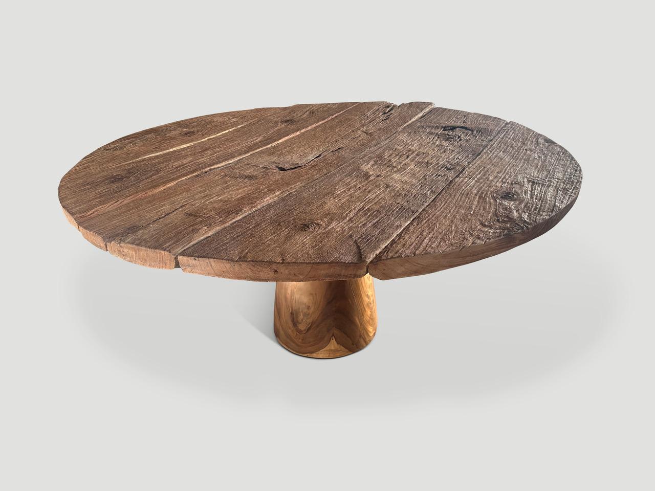 Reclaimed thick teak wood panels are joined together by hand to produce this impressive round table. A solid cylinder suar wood base allows the top to float. Great as a dining table or entrance table. Finished with a wire brush and natural oil