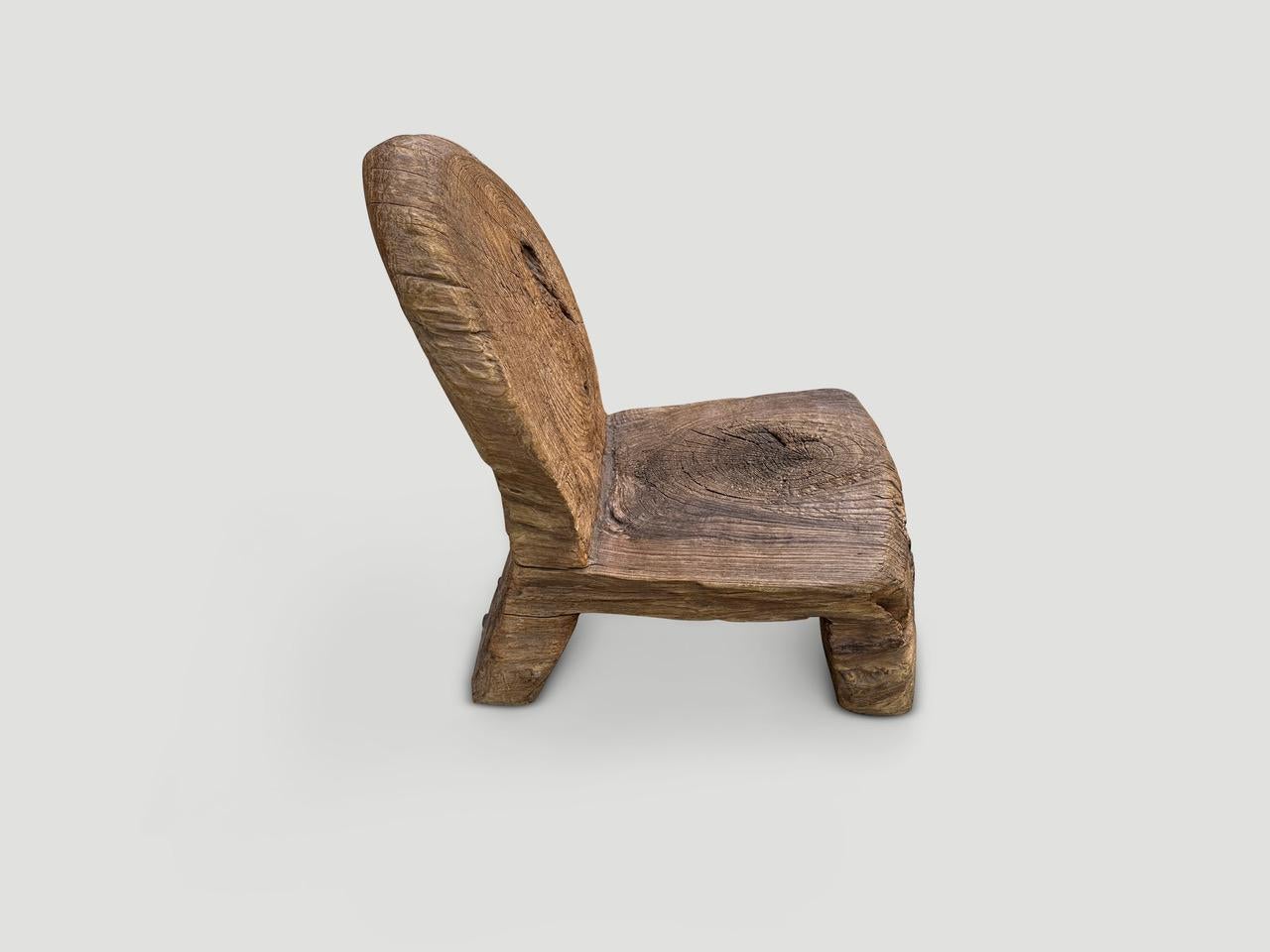 Century old unique sculptural chair, hand carved from a single block whilst respecting the natural organic beautiful teak wood. Both usable and a sculptural. Full dimensions ; 14.5″ wide x back 12″ wide x seat 16″ deep extends to 21″ deep x seat 11″