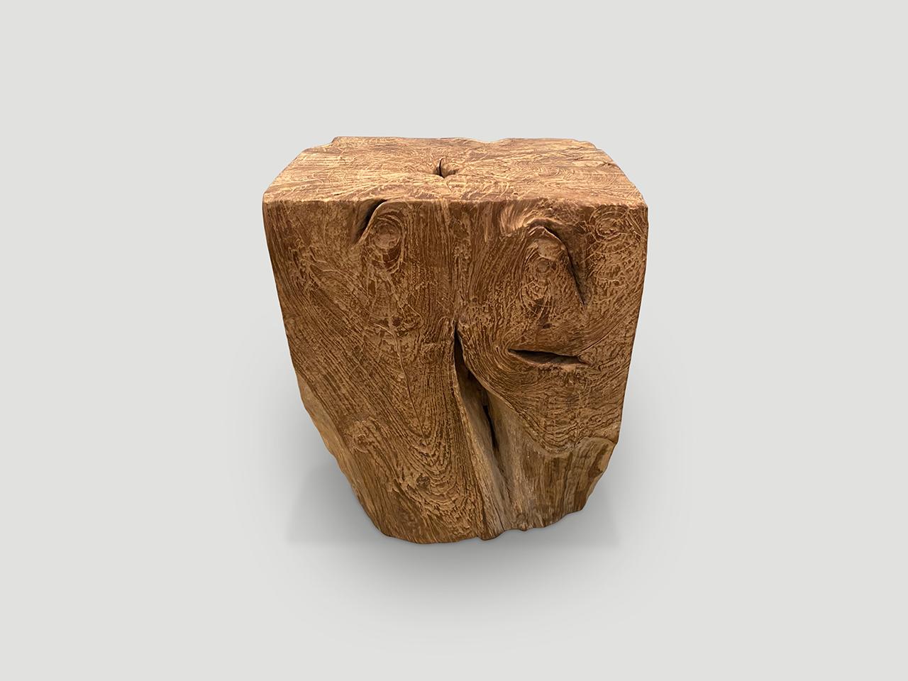 Beautiful aged teak wood carved into a minimalist side table or stool. 

This side table or stool was hand made in the spirit of Wabi-Sabi, a Japanese philosophy that beauty can be found in imperfection and impermanence. It is a beauty of things