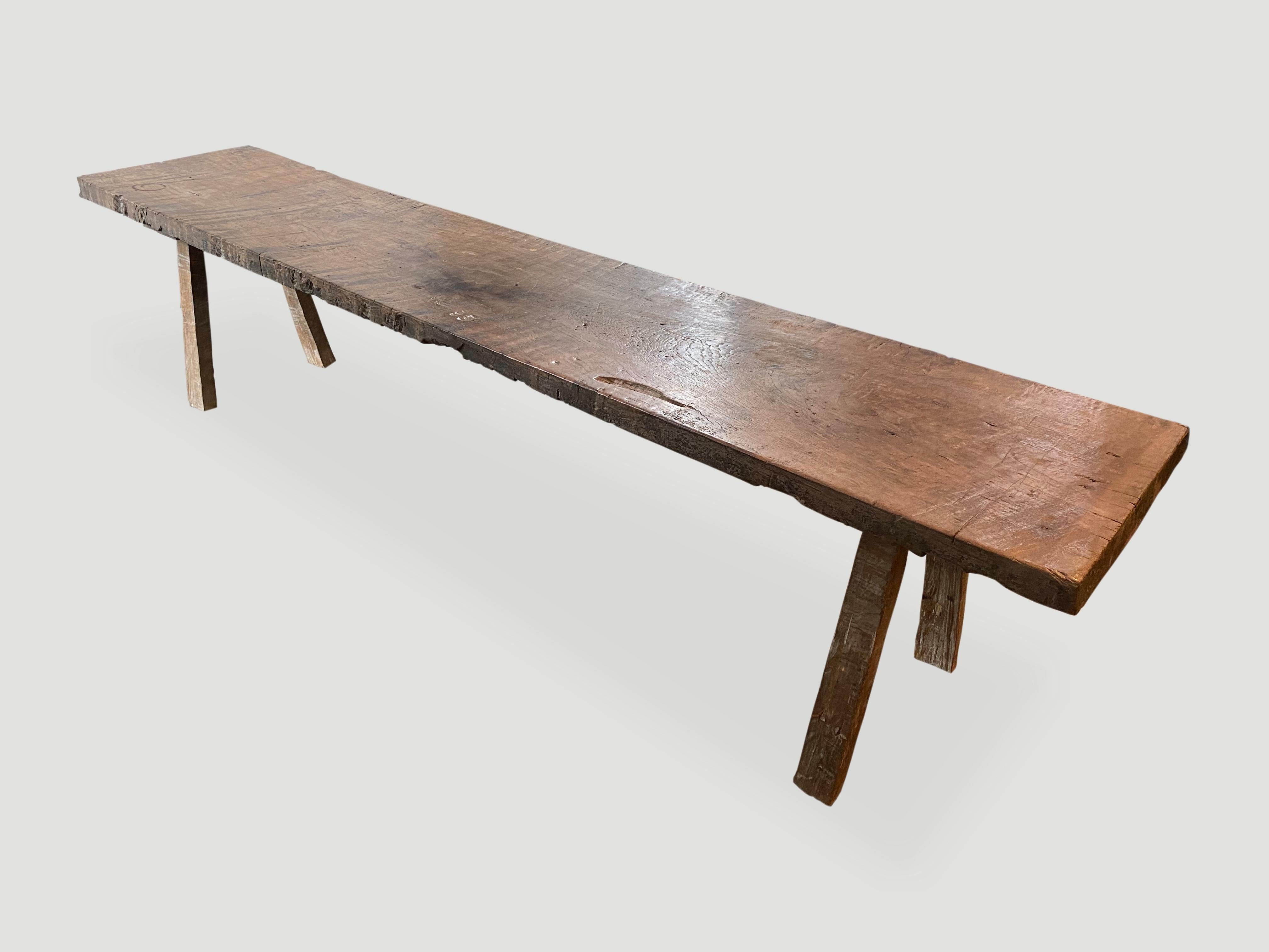 Antique single slab, natural aged teak wood bench. Celebrating the cracks and crevices and all the other marks that time and loving use have left behind.

This bench or coffee table was sourced in the spirit of wabi-sabi, a Japanese philosophy