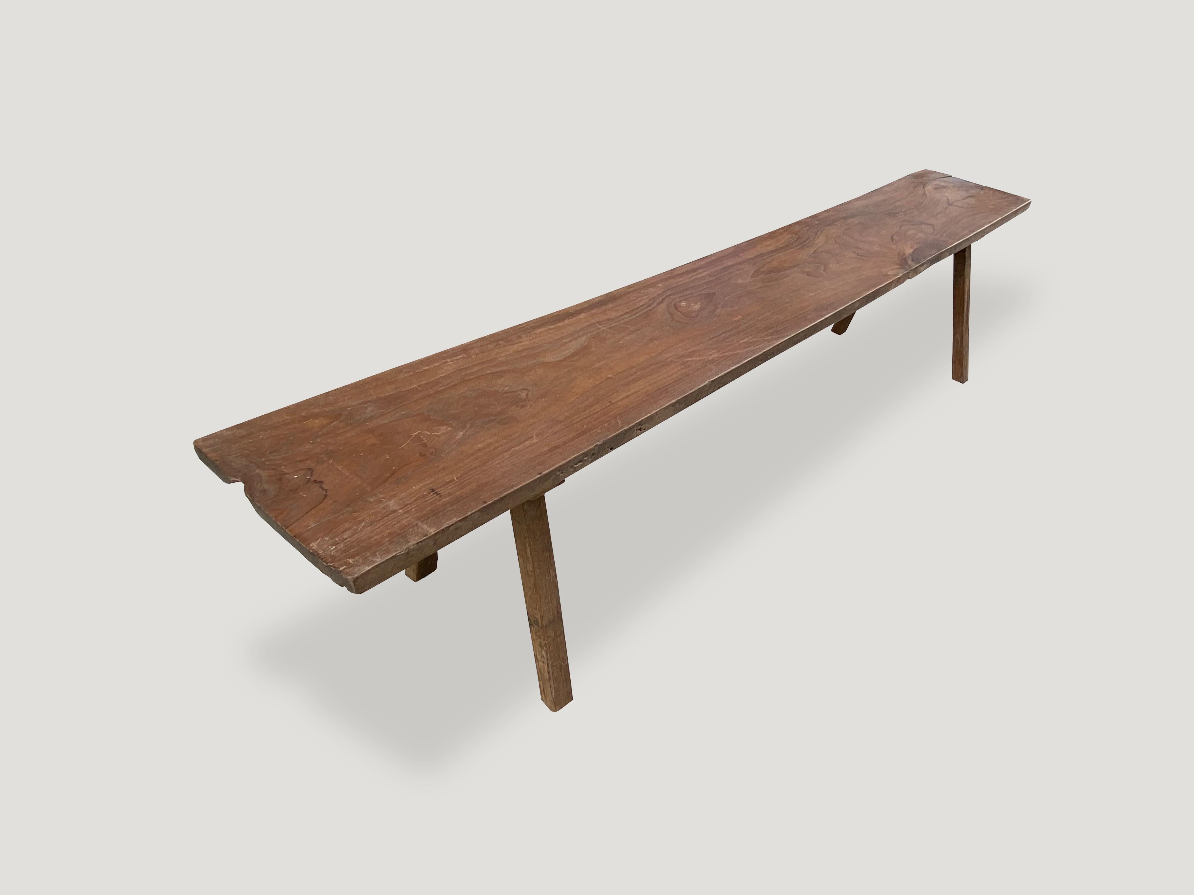 Antique single panel, natural aged teak wood bench. Celebrating the cracks and crevices and all the other marks that time and loving use have left behind. We have a pair cut from the same log. Both with beautiful grain. The price reflects the one