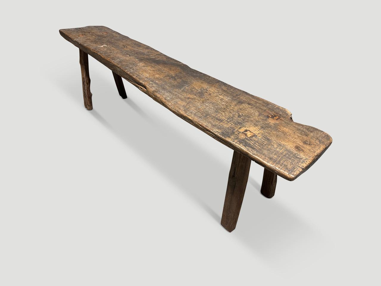 Antique bench hand made from a single panel of teak wood with lovely patina.

This bench was hand made in the spirit of Wabi-Sabi, a Japanese philosophy that beauty can be found in imperfection and impermanence. It is a beauty of things modest and