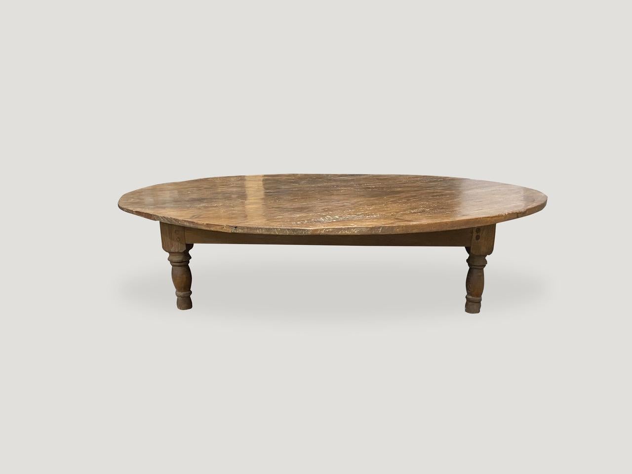 Lovely patina on this reclaimed teak wood antique coffee table with four hand carved legs. Floating on a minimalist base. Great for inside or outside use and light enough to bring inside during the harsh winters.

This coffee table was sourced in