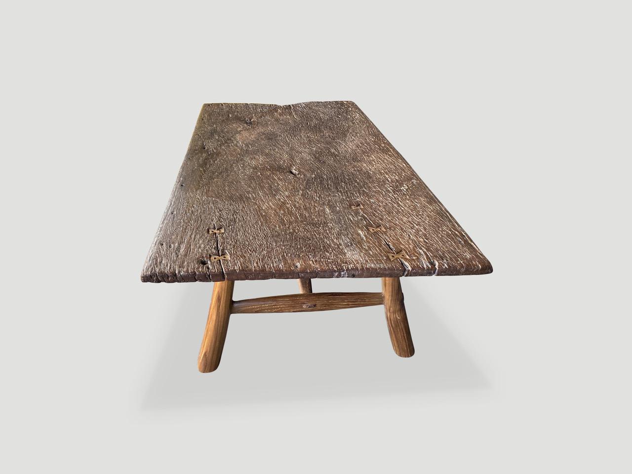 Fantastic wood grain on this single teak panel antique slab. Added butterfly detail and mid century style teak legs. Rare.

This coffee table was hand made in the spirit of Wabi-Sabi, a Japanese philosophy that beauty can be found in imperfection