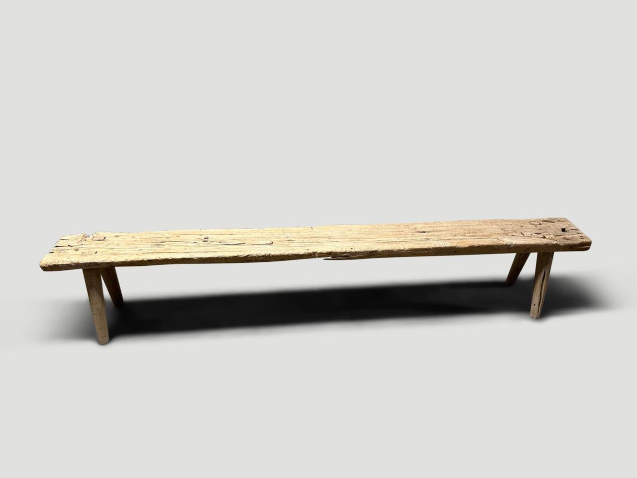Antique Wabi Sabi teak wood bench celebrating the cracks and crevices and all the other marks that time and loving use have left behind. We added smooth teak minimalist legs to this antique thick slab. It’s all in the details.

This bench was